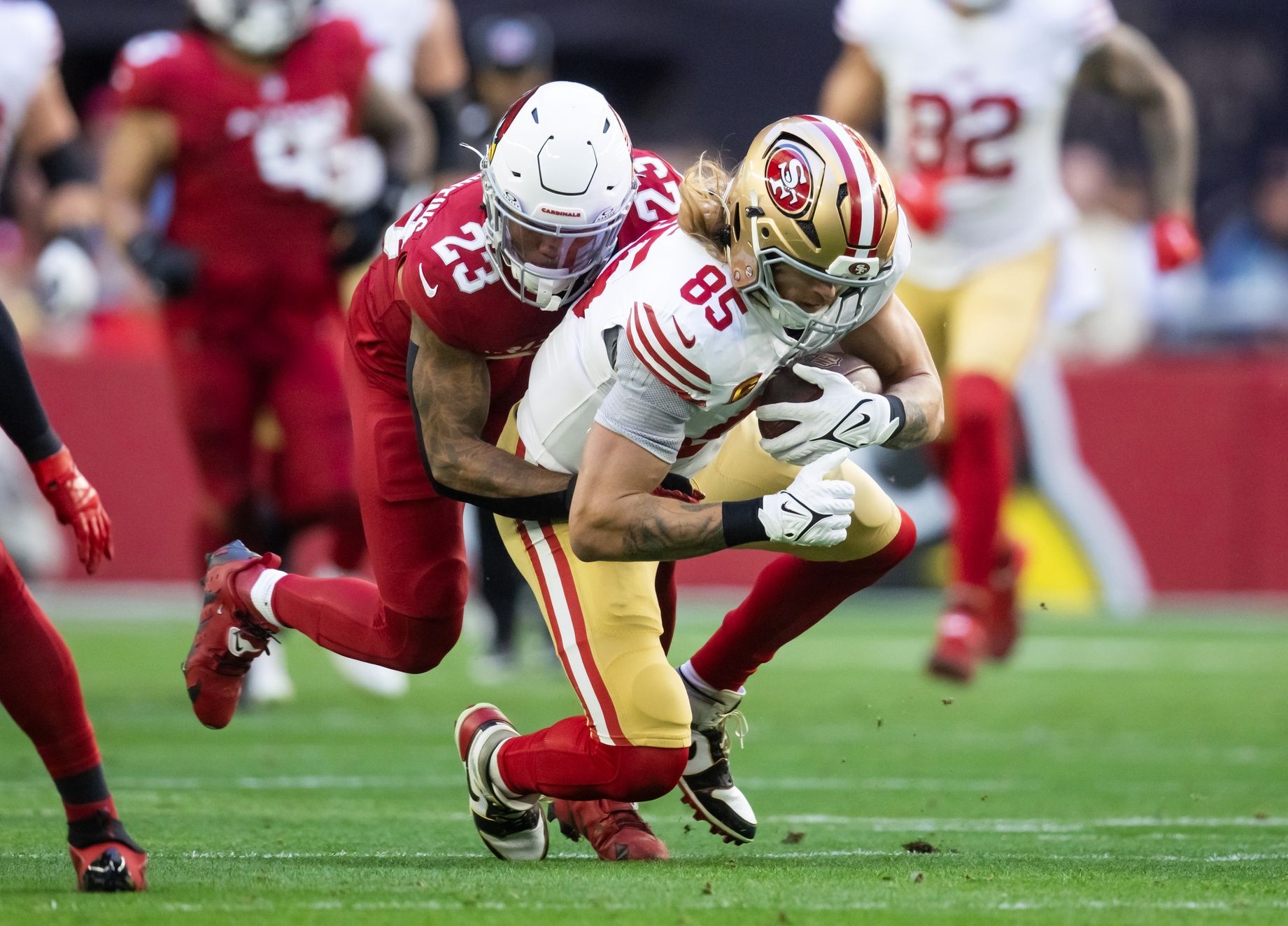San Francisco 49ers tight end George Kittle (85) is tackled by Arizona Cardinals cornerback Sean Murphy-Bunting (23) at State Farm Stadium.