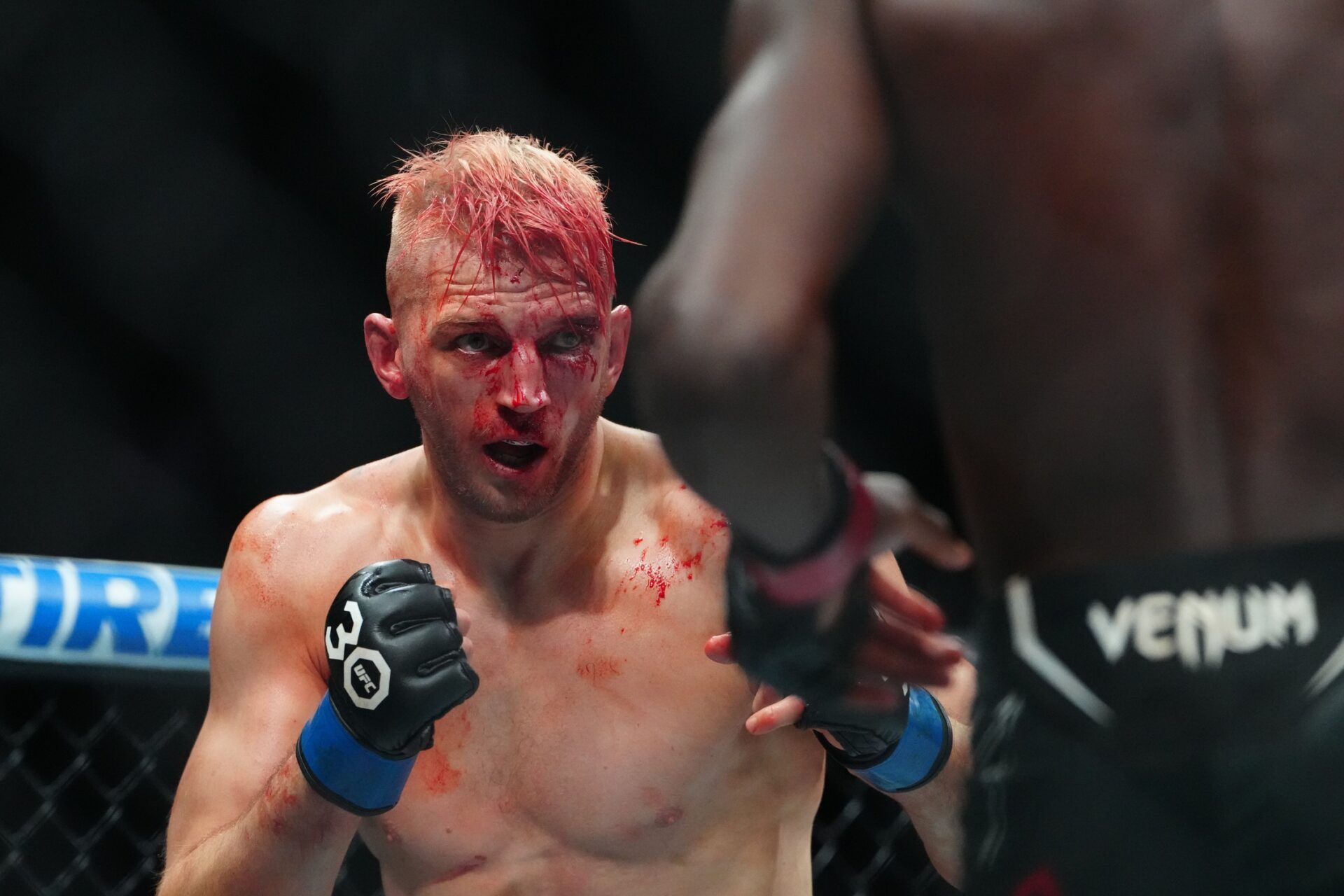 Jalin Turner (red gloves) fights Dan Hooker (blue gloves) during UFC 290 at T-Mobile Arena.