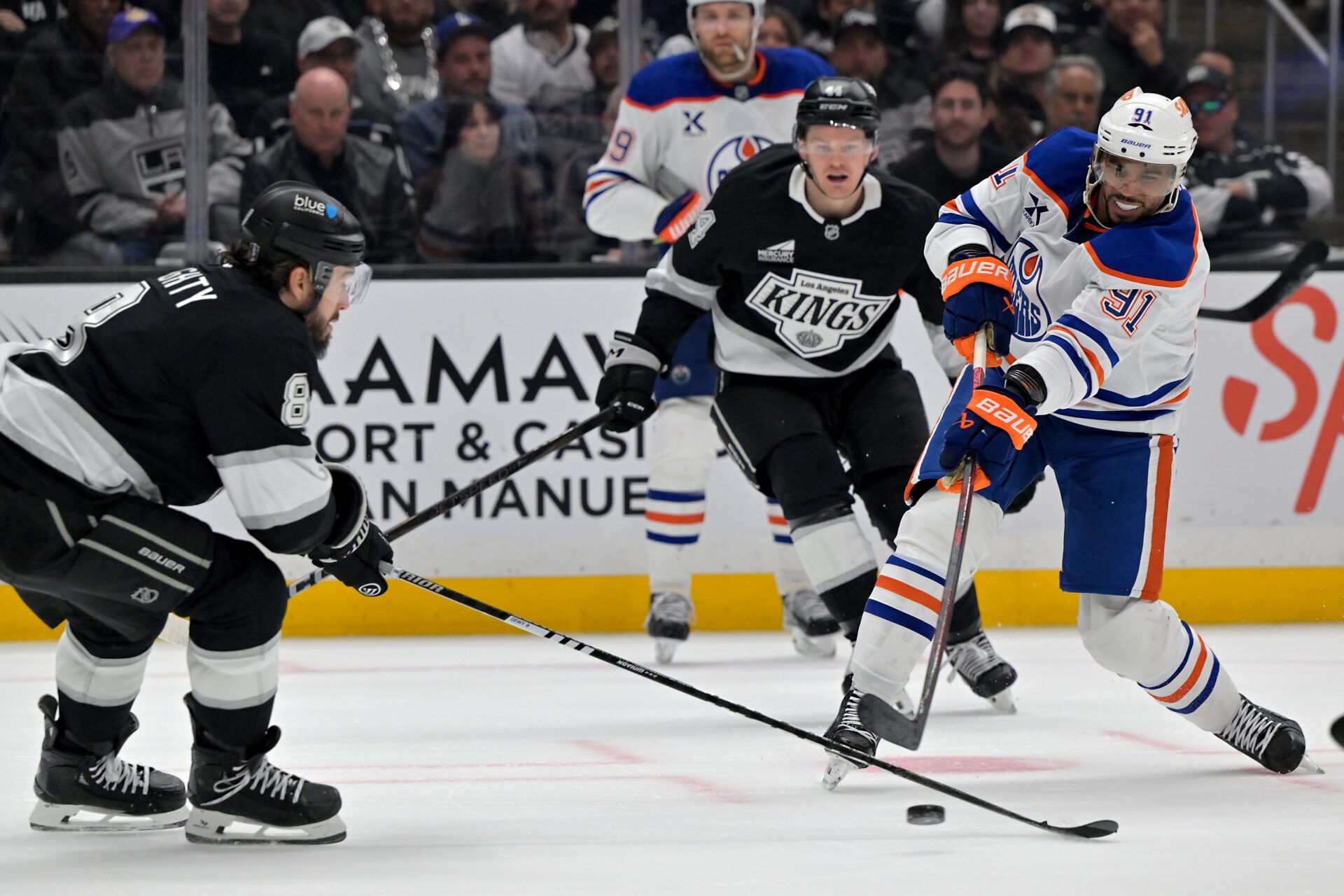 Apr 23, 2025; Los Angeles, California, USA; Edmonton Oilers left wing Evander Kane (91) takes a shot on goal past Los Angeles Kings center Anze Kopitar (11) in the third period of game 2 of the 2025 Stanley Cup Playoffs at Crypto.com Arena. Mandatory Credit: Jayne Kamin-Oncea-Imagn Images
