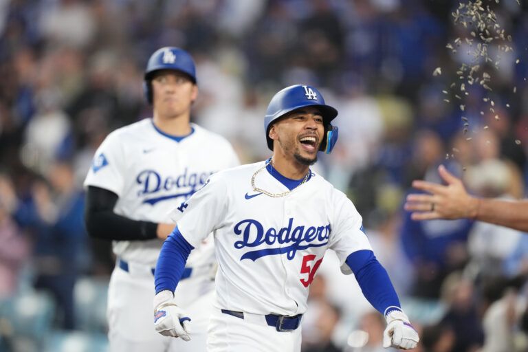 Apr 14, 2025; Los Angeles, California, USA; Los Angeles Dodgers shortstop Mookie Betts (50) receivers a sunflower seed shower outside the dugout after hitting a home run in the first inning against the Colorado Rockies at Dodger Stadium. Mandatory Credit: Kirby Lee-Imagn Images