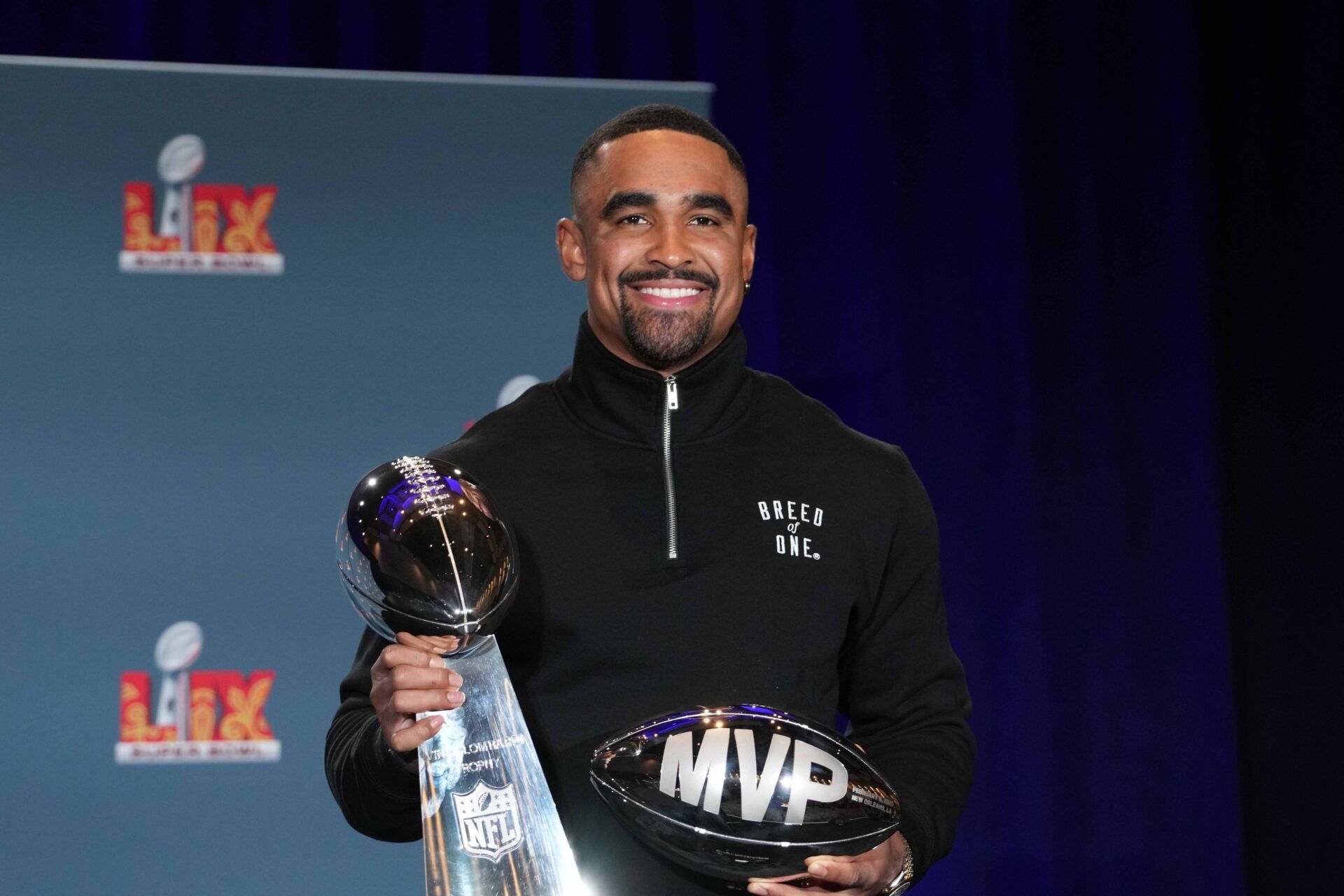 Philadelphia Eagles quarterback Jalen Hurts (1) poses with the Vince Lombardi trophy at the Super Bowl LIX Winning Head Coach and Most Valuable Player press conference at the Ernest N. Morial Convention Center.