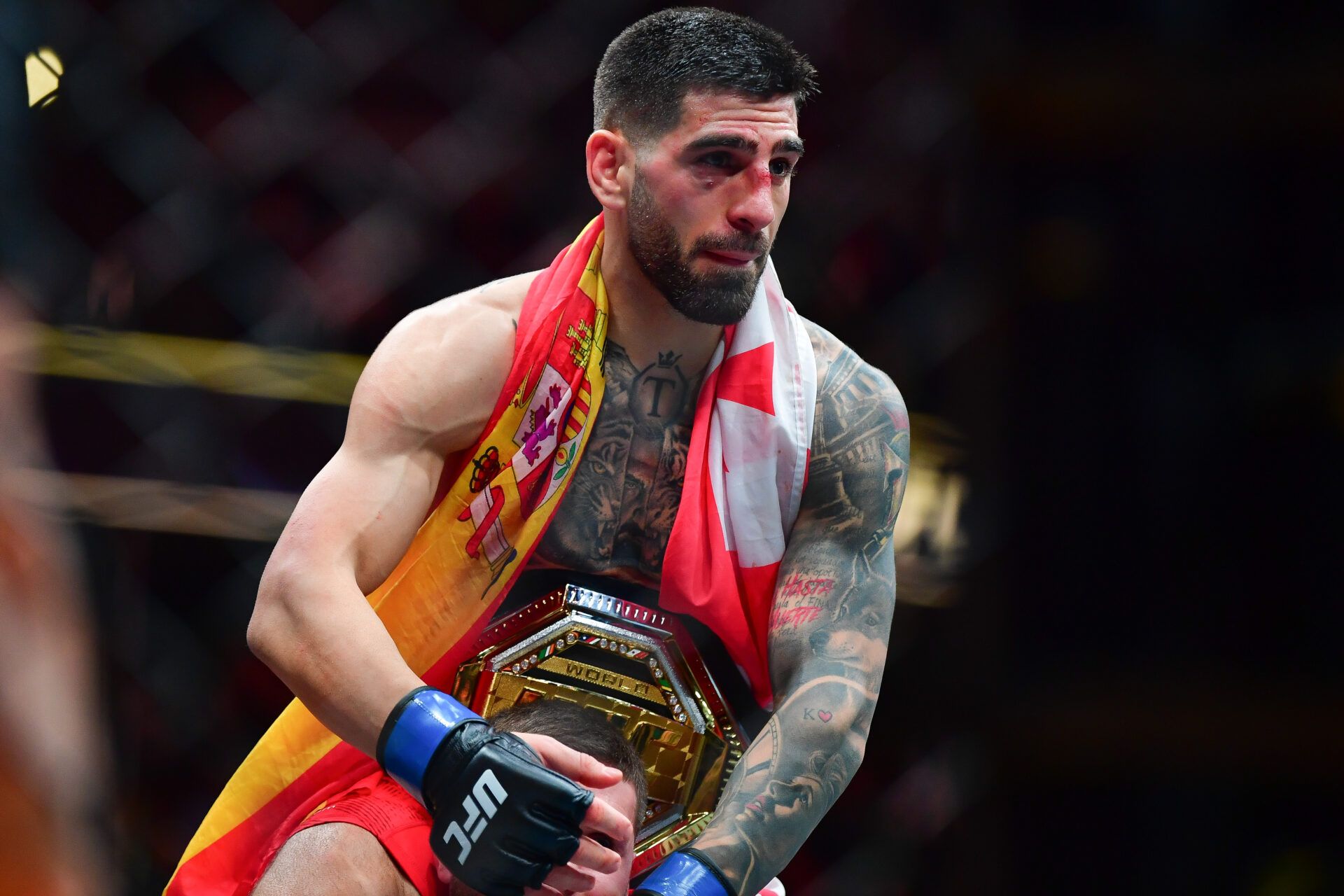 Feb 17, 2024; Anaheim, California, USA; Ilia Topuria celebrates his championship victory against Alexander Volkanovski during UFC 298 at Honda Center. Mandatory Credit: Gary A. Vasquez-USA TODAY Sports