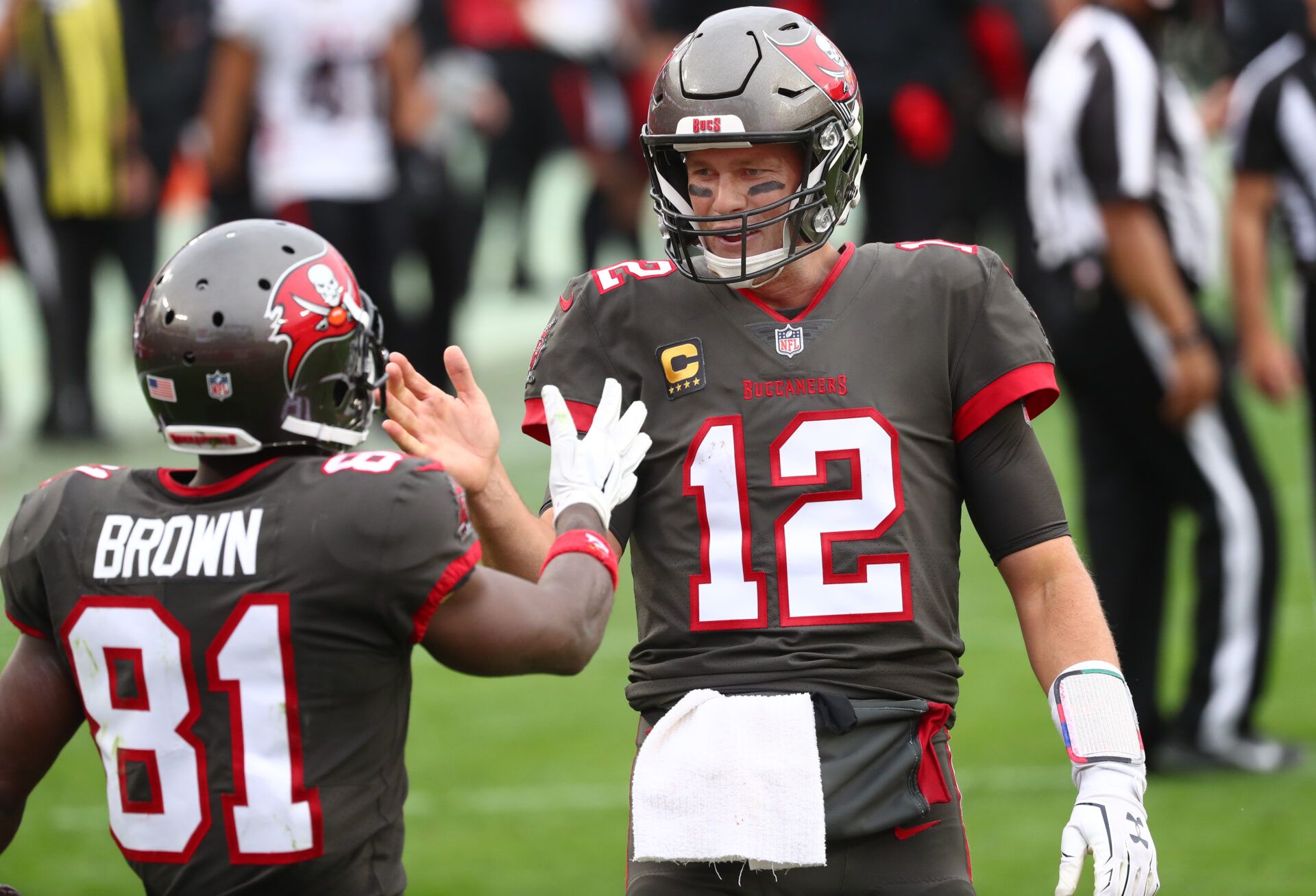 Jan 3, 2021; Tampa, Florida, USA; Tampa Bay Buccaneers quarterback Tom Brady (12) smiles with wide receiver Antonio Brown (81) after he scored a touchdown against the Atlanta Falcons during the second half at Raymond James Stadium. Mandatory Credit: Kim Klement-USA TODAY Sports