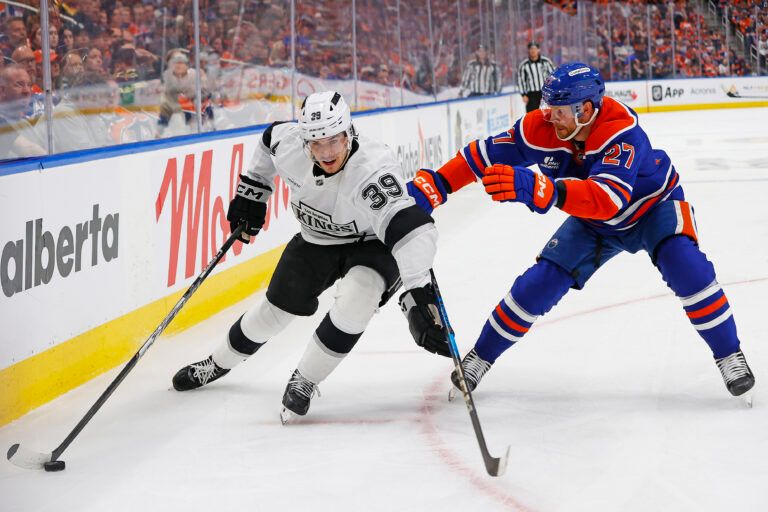 May 1, 2025; Edmonton, Alberta, CAN; Los Angeles Kings forward Jeff Malott (39) protects the puck from Edmonton Oilers defensemen Brett Kulak (27) during the second period in game six of the first round of the 2025 Stanley Cup Playoffs at Rogers Place. Mandatory Credit: Perry Nelson-Imagn Images