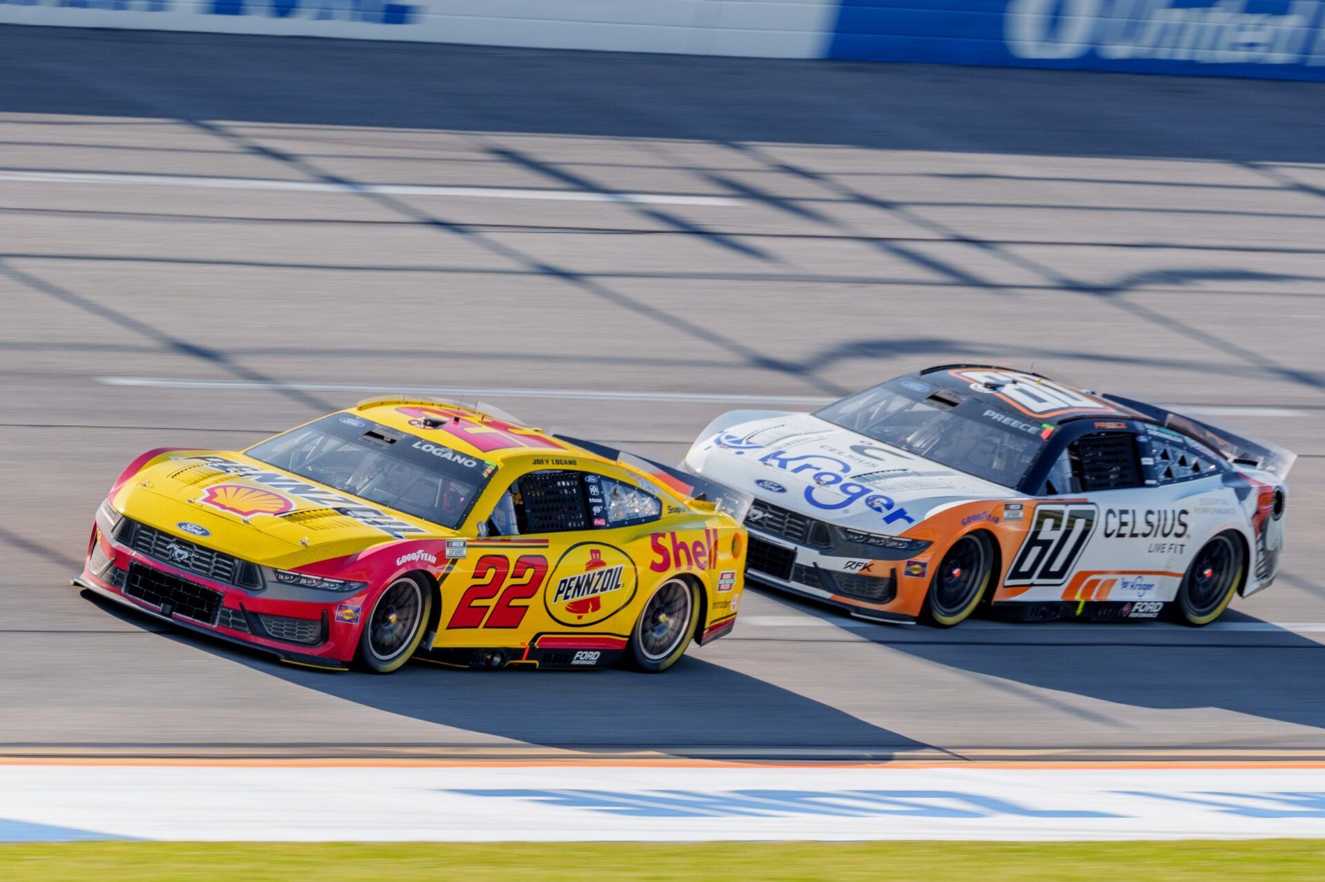 NASCAR Cup Series driver Joey Logano (22) and NASCAR Cup Series driver Ryan Preece (60) go into turn one at Talladega Superspeedway.