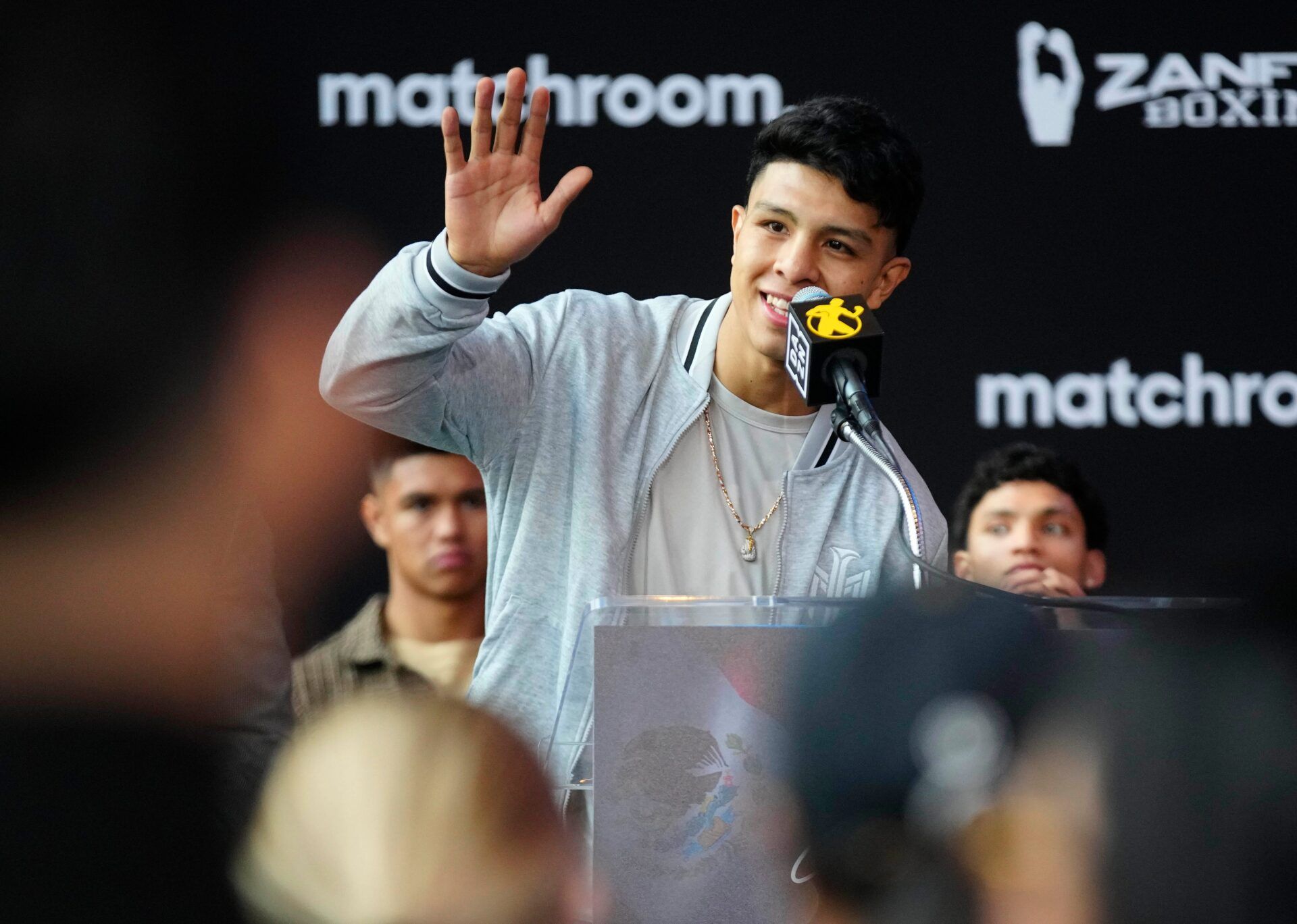 Jan. 25, 2024; Phoenix, Ariz; USA; Jaime Munguia waves to his family as he speaks during a press conference for Golden Boy boxing event.