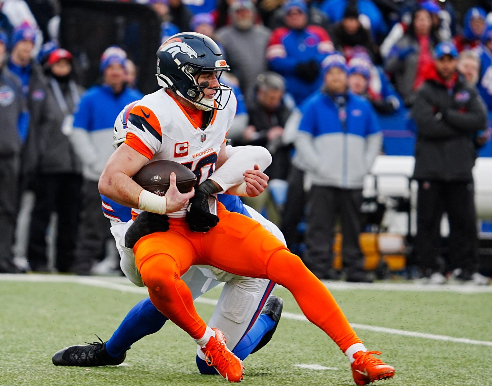 Denver Broncos quarterback Bo Nix (10) gets sacked by Buffalo Bills defensive end Greg Rousseau (50) during the second half of the Buffalo Bills wild card game against the Denver Broncos at Highmark Stadium in Orchard Park on Jan. 12, 2025.