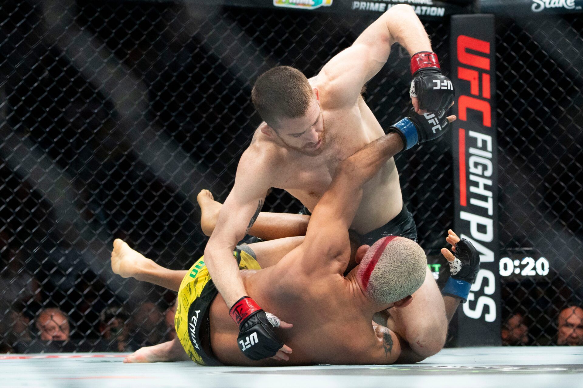 Cory Sandhagen (red gloves) fights with Deiveson Figueiredo (blue gloves) during UFC Fight Night at Wells Fargo Arena on May 3, 2025, in Des Moines.