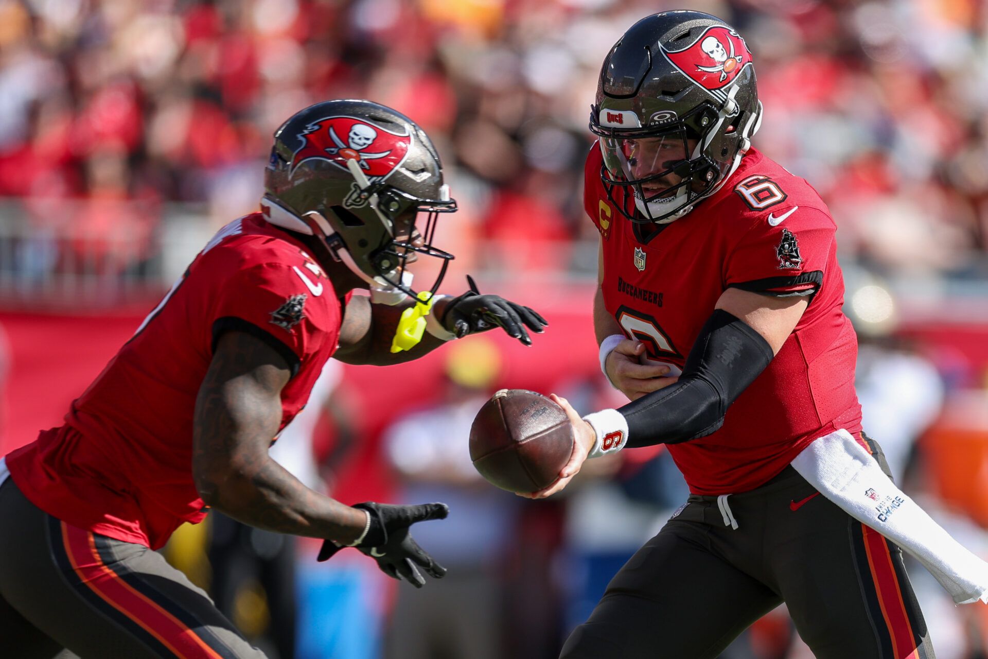 Jan 5, 2025; Tampa, Florida, USA; Tampa Bay Buccaneers quarterback Baker Mayfield (6) hands off to running back Bucky Irving (7) against the New Orleans Saints in the second quarter at Raymond James Stadium. Mandatory Credit: Nathan Ray Seebeck-Imagn Images