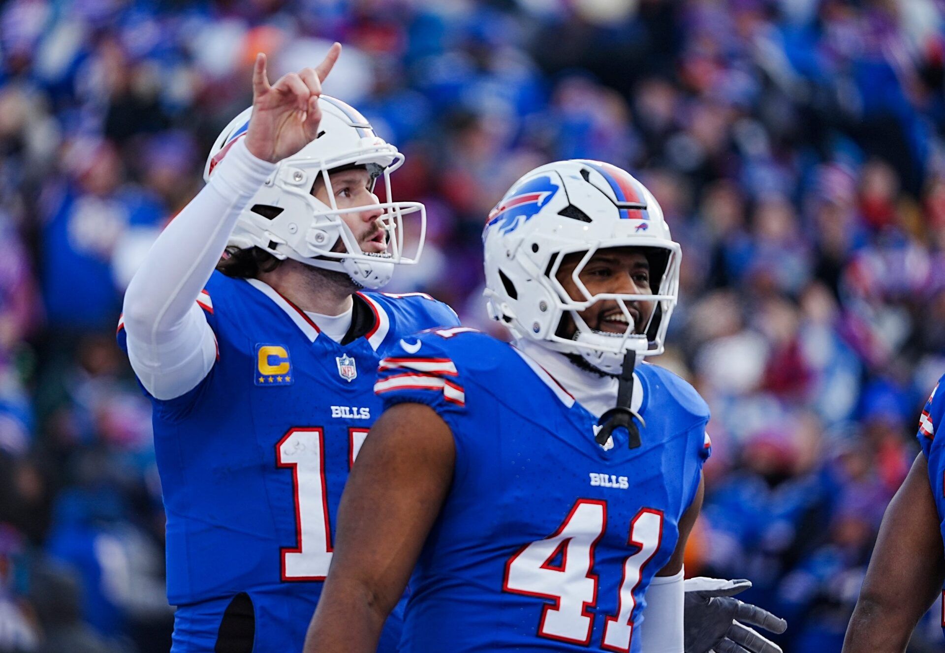 Buffalo Bills quarterback Josh Allen signals they are going for the two-point conversion during the second half of the Buffalo Bills wild card game against the Denver Broncos at Highmark Stadium in Orchard Park on Jan. 12, 2025. Smiling about the touchdown is Buffalo Bills fullback Reggie Gilliam.