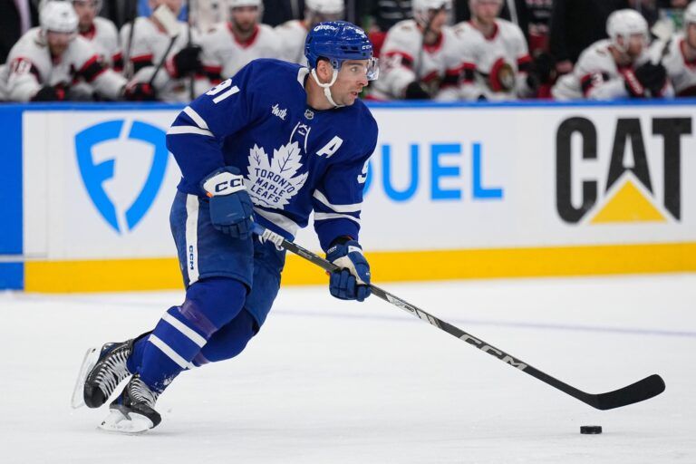 Toronto Maple Leafs forward John Tavares (91) carries the puck against the Ottawa Senators during the second period of game one of the first round of the 2025 Stanley Cup Playoffs at Scotiabank Arena.