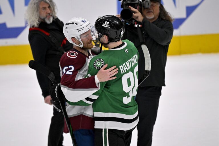 Colorado Avalanche left wing Gabriel Landeskog (92) hugs Dallas Stars right wing Mikko Rantanen (96) after the Stars defeats the Avalanche in game seven of the first round of the 2025 Stanley Cup Playoffs at American Airlines Center.