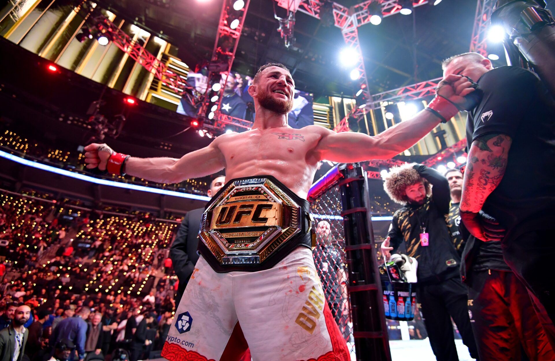 Jan 18, 2025; Inglewood, California, USA; Merab Dvalishvili (red gloves) celebrates after winning a UFC bantamweight title fight against Umar Nurmagomedov (not pictured) during UFC 311 at Intuit Dome. Mandatory Credit: Gary A. Vasquez-Imagn Images