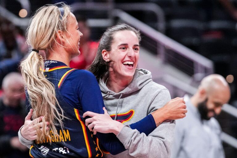 Indiana Fever Sophie Cunningham (8) hugs Indiana Fever Caitlin Clark (22) on Saturday, May 3, 2025, during a preseason game between the Indiana Fever and the Washington Mystics at Gainbridge Fieldhouse in Indianapolis. The Indiana Fever defeated the Washington Mystics in overtime, 79-74.