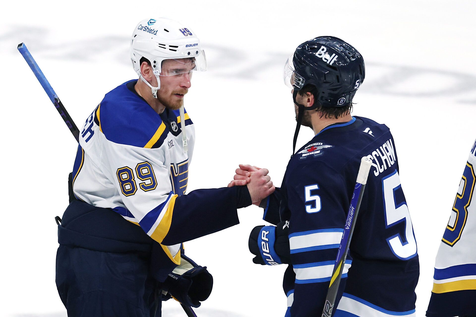 May 4, 2025; Winnipeg, Manitoba, CAN; St. Louis Blues left wing Pavel Buchnevich (89) and Winnipeg Jets defenseman Luke Schenn (5) shake hands after the Winnipeg Jets won in double overtime in game seven of the first round of the 2025 Stanley Cup Playoffs at Canada Life Centre. Mandatory Credit: James Carey Lauder-Imagn Images