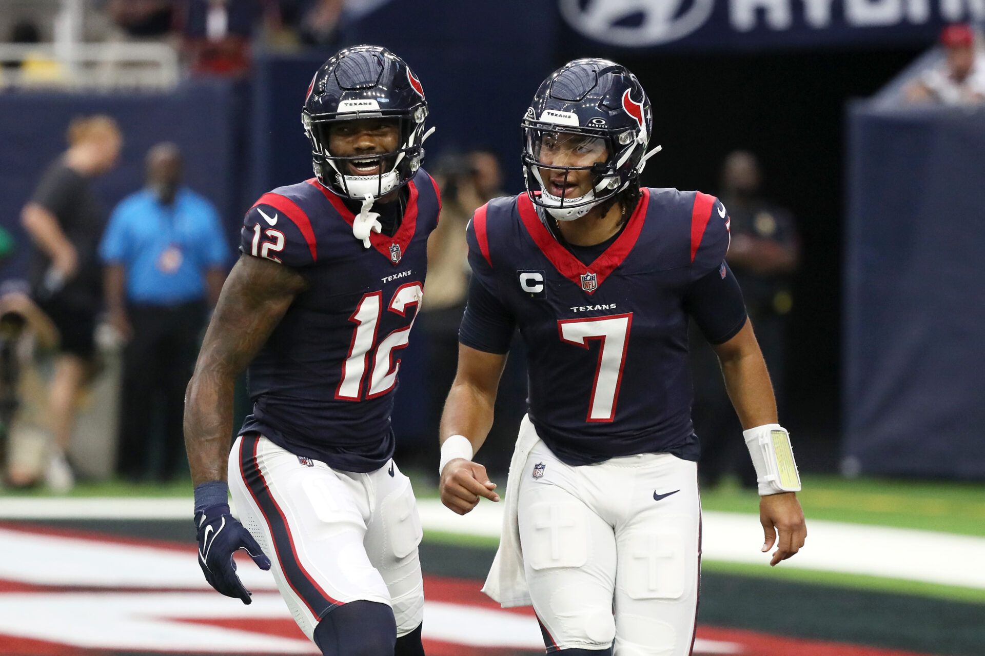 HOUSTON, TEXAS - NOVEMBER 05: Nico Collins #12 of the Houston Texans and C.J. Stroud #7 react after a touchdown in the first quarter of a game against the Tampa Bay Buccaneers at NRG Stadium on November 05, 2023 in Houston, Texas. (Photo by Bob Levey/Getty Images)
