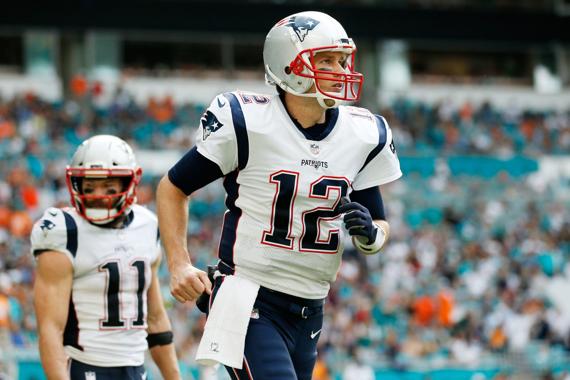 MIAMI, FL - DECEMBER 09: Tom Brady #12 of the New England Patriots celebrates after setting the new record for touchdown passes in the regular season and playoffs combined with teammate Julian Edelman #11, who scored the touchdown, in the second quarter at Hard Rock Stadium on December 9, 2018 in Miami, Florida. (Photo by Michael Reaves/Getty Images)
