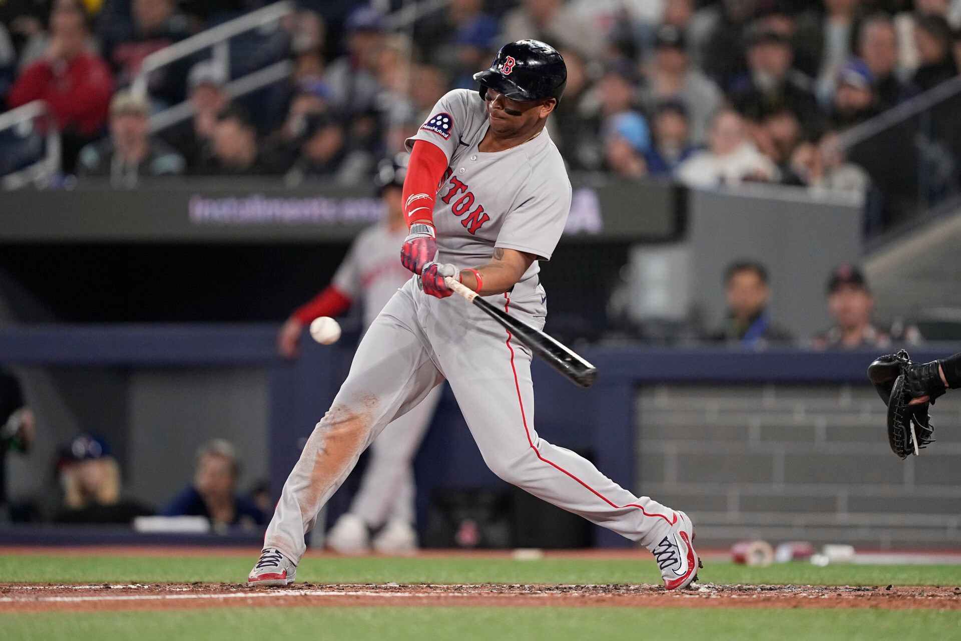 Boston Red Sox designated hitter Rafael Devers (11) hits a one-run double against the Toronto Blue Jays during the second inning at Rogers Centre.