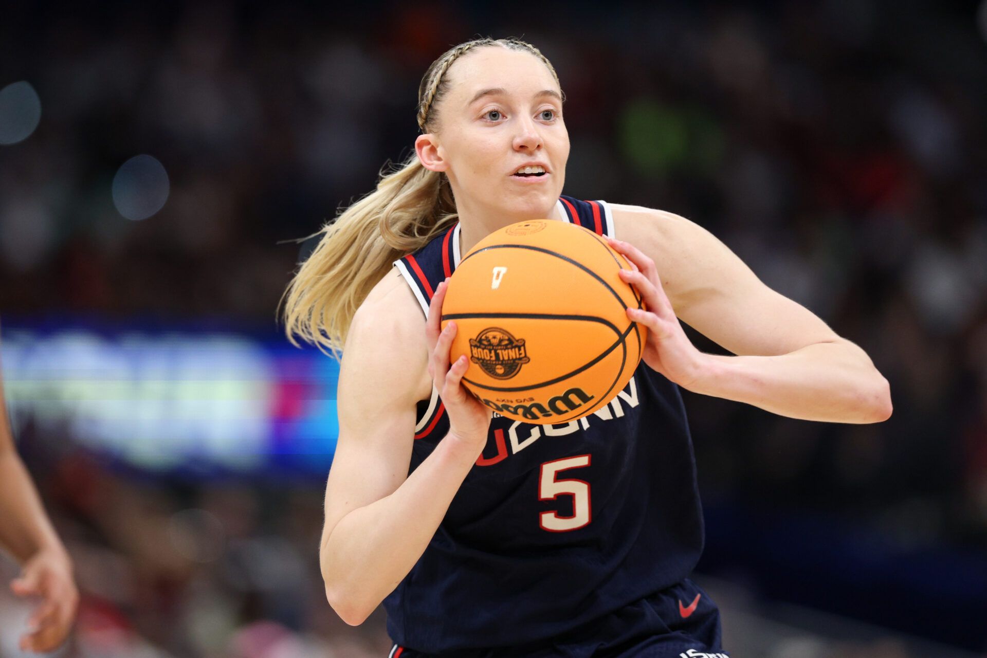 Apr 6, 2025; Tampa, FL, USA; Connecticut Huskies guard Paige Bueckers (5) passes the ball against the South Carolina Gamecocks during the first half of the national championship of the women's 2025 NCAA tournament at Amalie Arena. Mandatory Credit: Nathan Ray Seebeck-Imagn Images