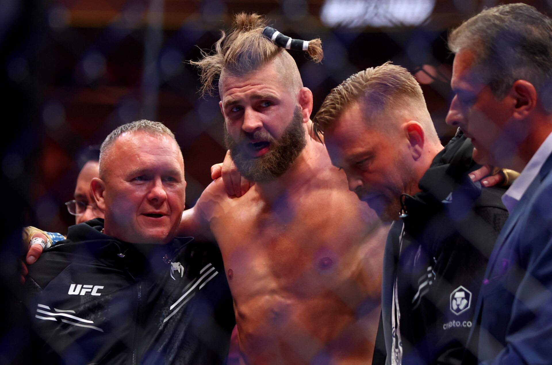 Jun 29, 2024; Las Vegas, Nevada, USA; Jiri Prochazka (blue gloves) is helped after losing to Alex Pereira (not pictured) during UFC 303 at T-Mobile Arena. Mandatory Credit: Mark J. Rebilas-USA TODAY Sports