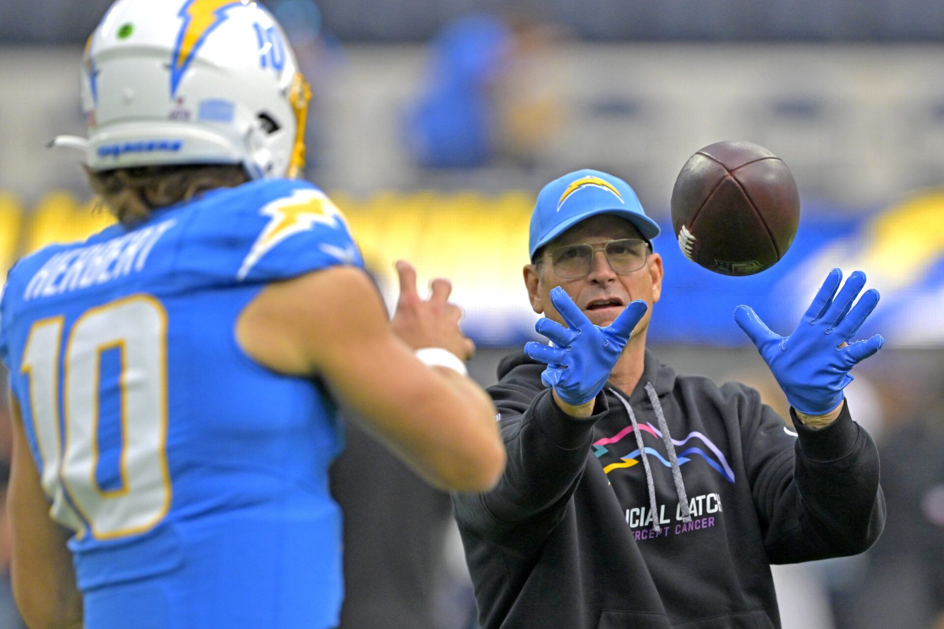 Oct 27, 2024; Inglewood, California, USA; Los Angeles Chargers quarterback Justin Herbert (10) warms up with head coach Jim Harbaugh prior to the game against the Los Angeles Chargers at SoFi Stadium. Mandatory Credit: Jayne Kamin-Oncea-Imagn Images