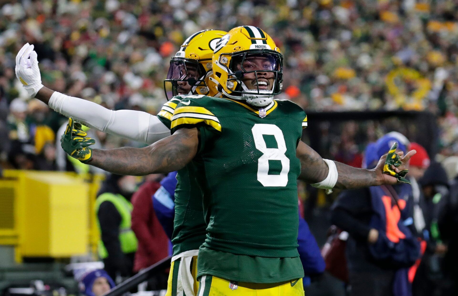 Green Bay Packers running back Josh Jacobs (8) celebrates scoring a touchdown with wide receiver Bo Melton (80) against the San Francisco 49ers during their football game Sunday, November 24, 2024, at Lambeau Field in Green Bay, Wisconsin.
