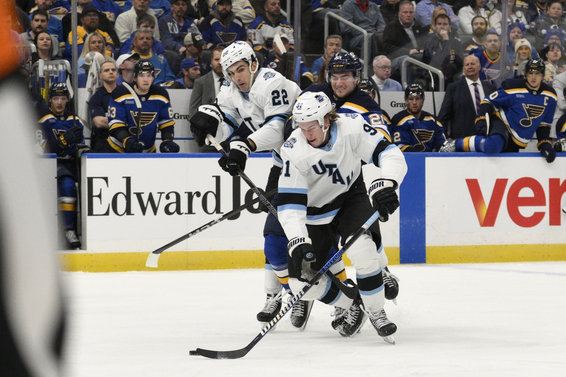 Apr 15, 2025; St. Louis, Missouri, USA; Utah Hockey Club right wing Josh Doan (91) and center Jack McBain (22) battle St. Louis Blues right wing Jimmy Snuggerud (21) during the second period at Enterprise Center. Mandatory Credit: Jeff Le-Imagn Images