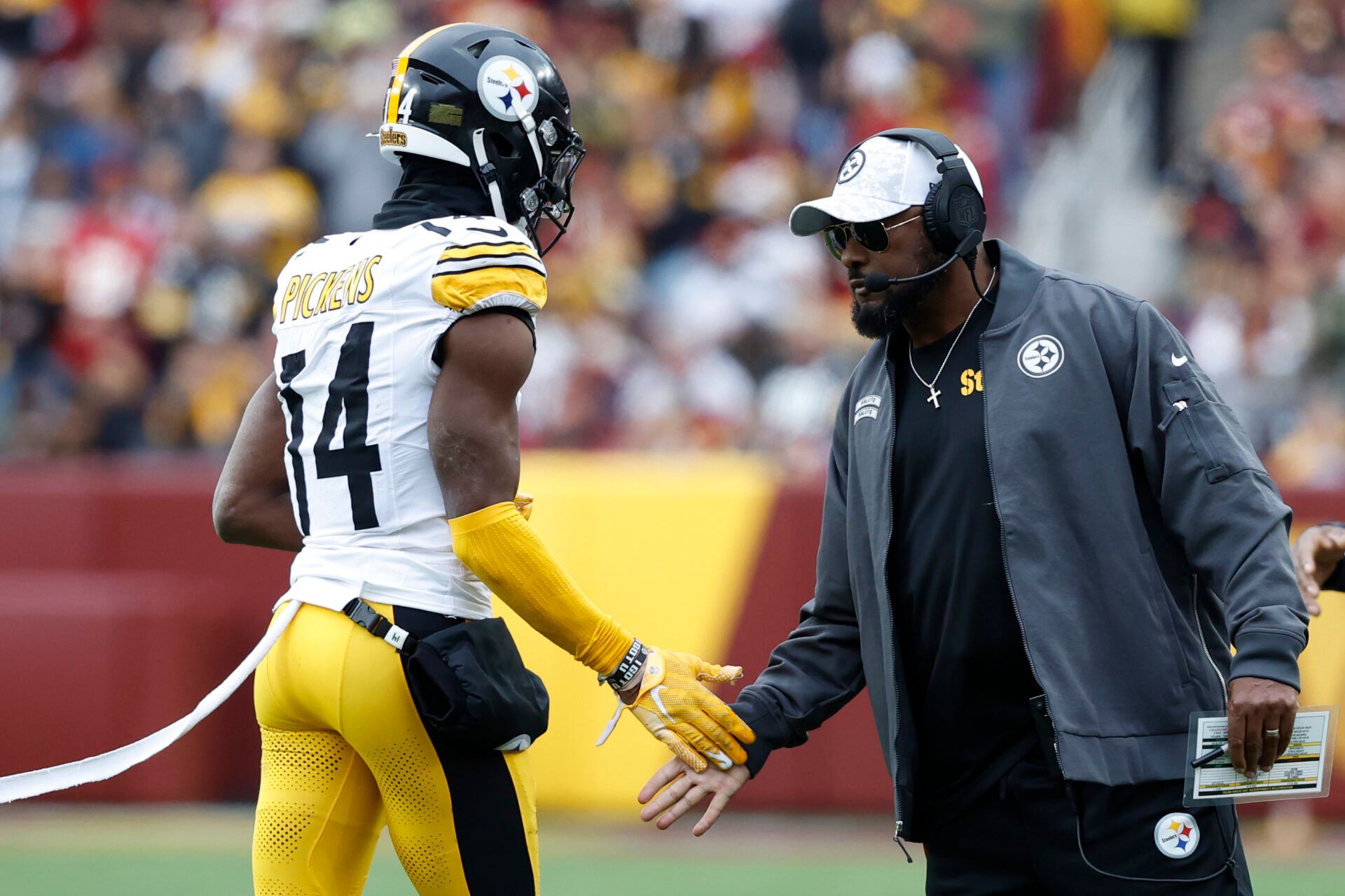Nov 10, 2024; Landover, Maryland, USA; Pittsburgh Steelers head coach Mike Tomlin (R) congratulates Steelers wide receiver George Pickens (14) after a long catch against the Washington Commanders during the second half at Northwest Stadium. Mandatory Credit: Geoff Burke-Imagn Images