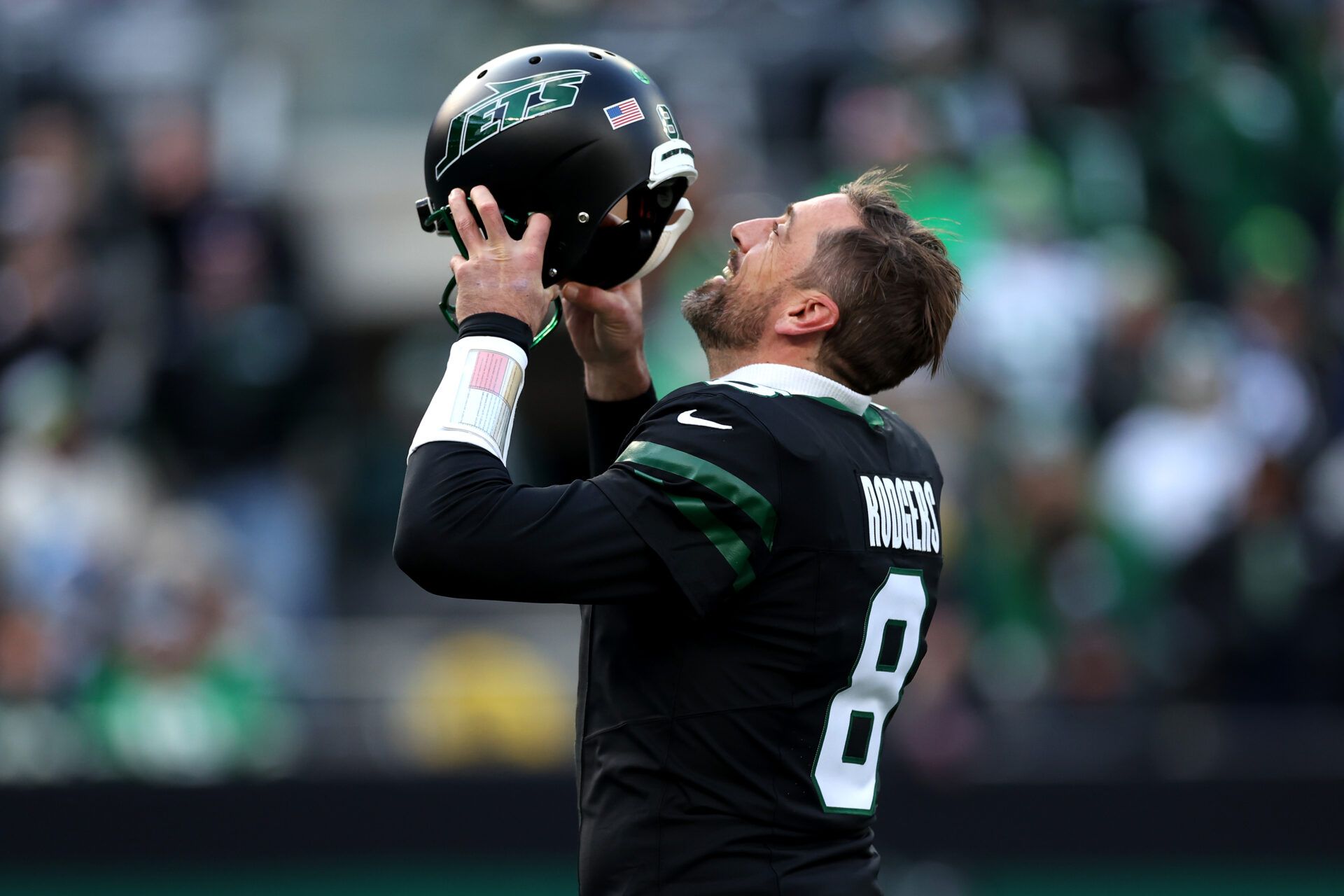 EAST RUTHERFORD, NEW JERSEY - DECEMBER 01: Aaron Rodgers #8 of the New York Jets puts on his helmet against the Seattle Seahawks during the first quarter at MetLife Stadium on December 01, 2024 in East Rutherford, New Jersey. (Photo by Luke Hales/Getty Images)