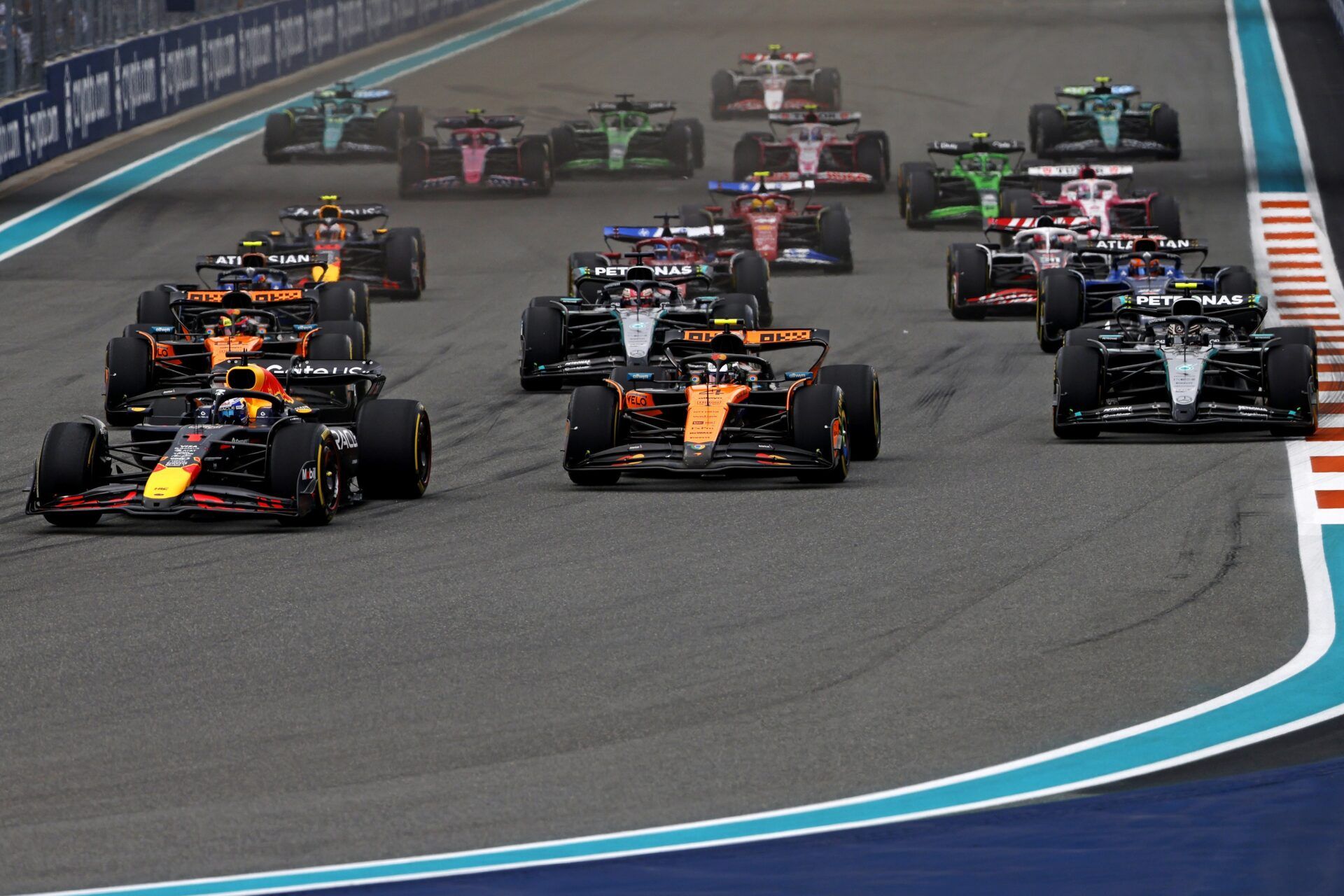 Red Bull driver Max Verstappen (1) leads the start of the F1 Miami Grand Prix at Miami International Autodrome.