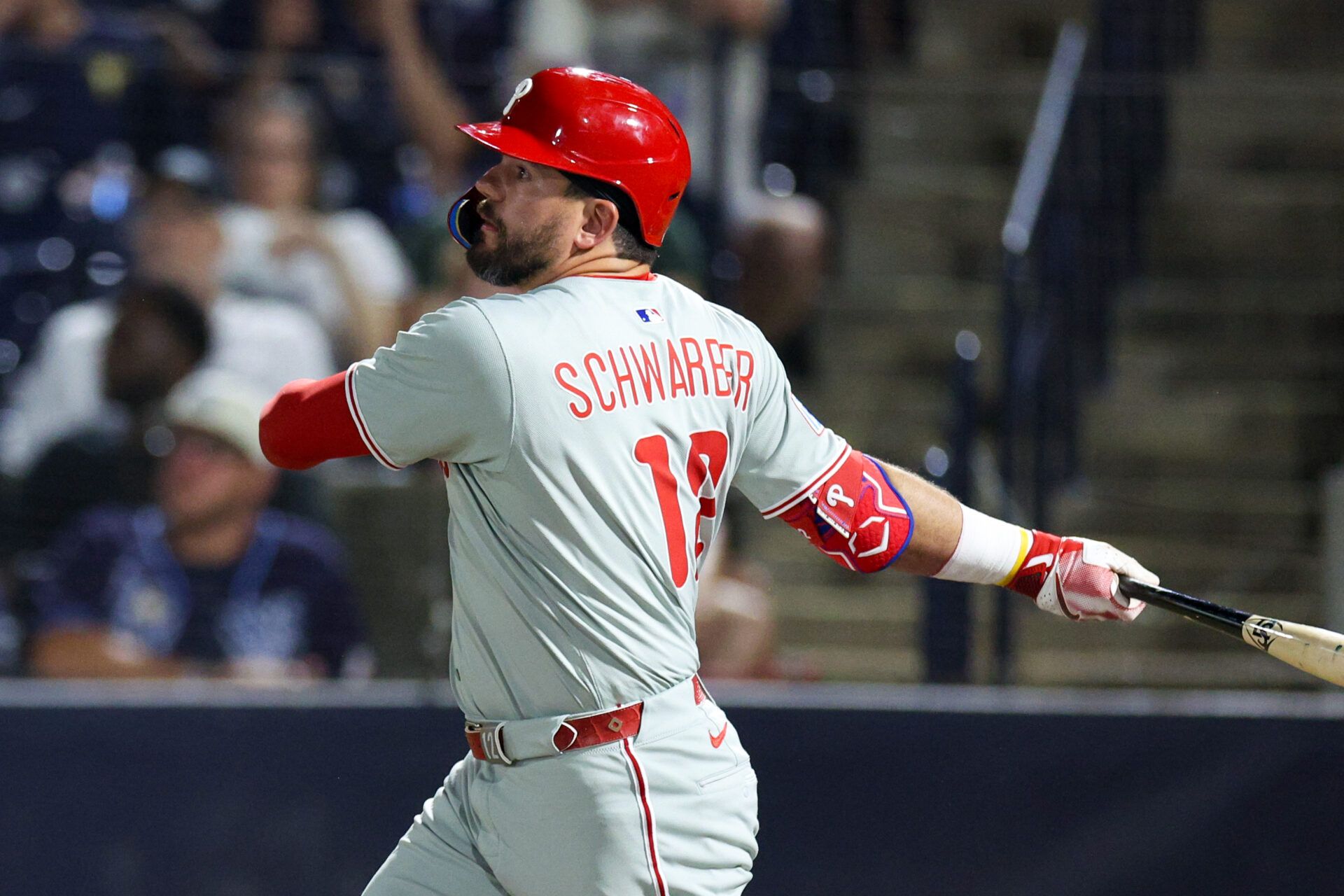 Philadelphia Phillies designated hitter Kyle Schwarber (12) hits an rbi single against the Tampa Bay Rays in the eighth inning at George M. Steinbrenner Field.