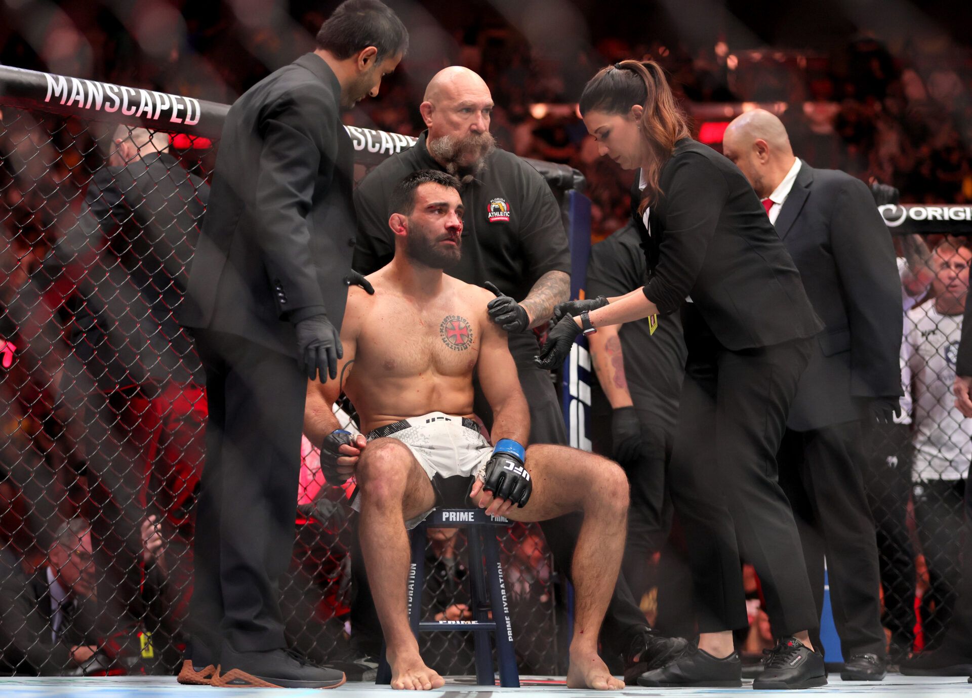 Mar 9, 2024; Miami, Florida, USA; Benoit Saint Denis is checked by medical staff members after his loss to Dustin Poirier during UFC 299 at Kayesa Center. Mandatory Credit: Sam Navarro-USA TODAY Sports