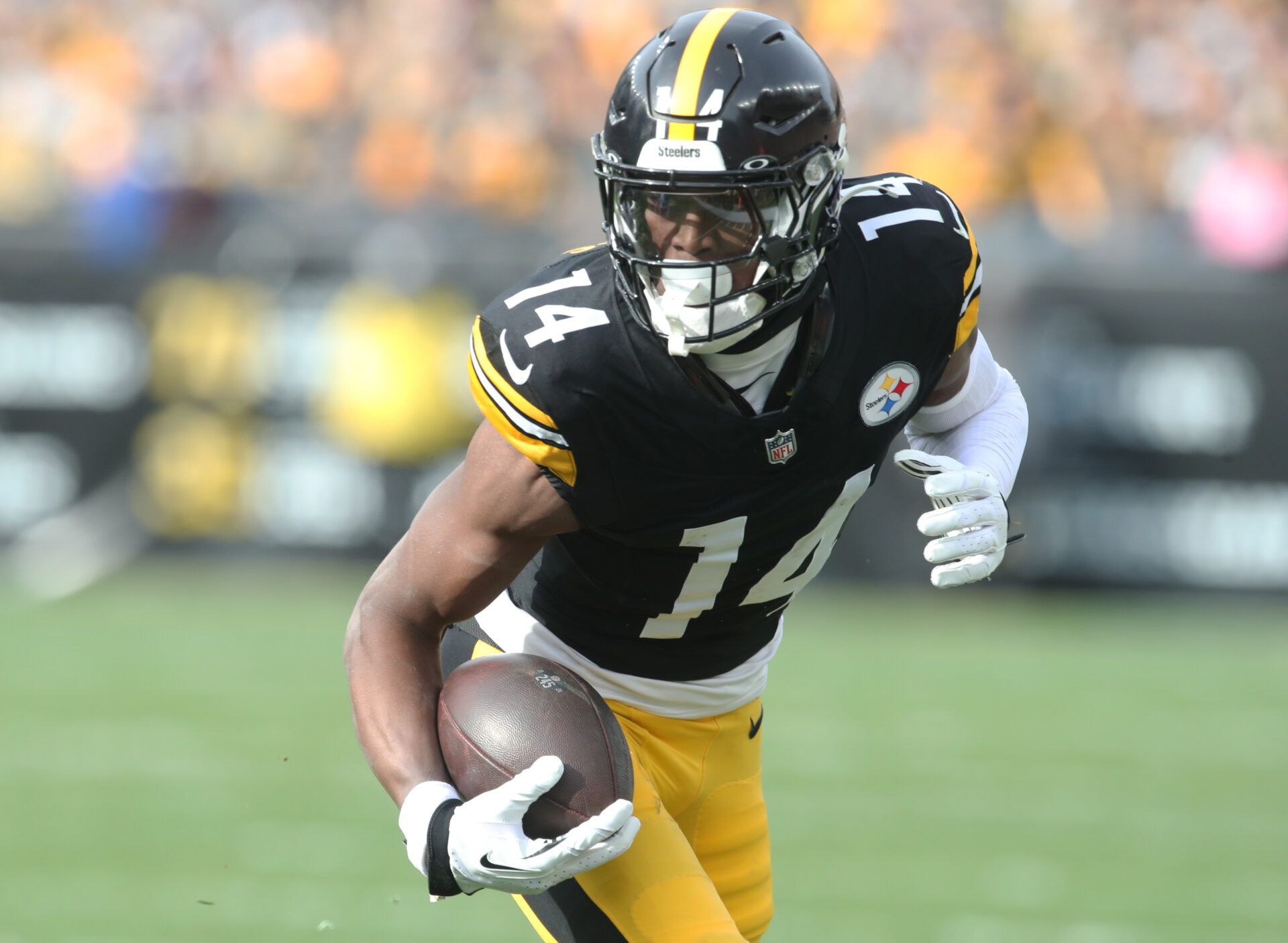Nov 17, 2024; Pittsburgh, Pennsylvania, USA; Pittsburgh Steelers wide receiver George Pickens (14) runs after a catch against the Baltimore Ravens during the first quarter at Acrisure Stadium. Mandatory Credit: Charles LeClaire-Imagn Images