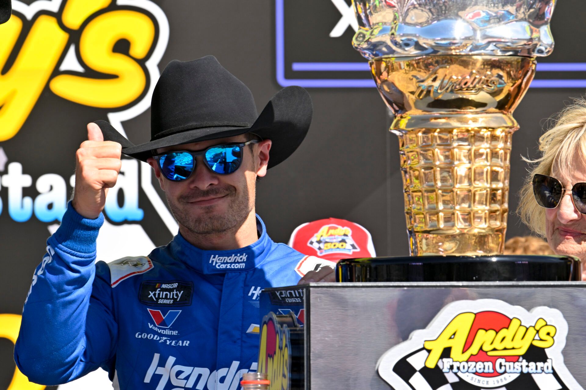 May 3, 2025; Fort Worth, Texas, USA; NASCAR Xfinity Series driver Kyle Larson (88) tries on a cowboy hat in Victory Lane after he wins the NASCAR Xfinity race at Texas Motor Speedway. Mandatory Credit: Jerome Miron-Imagn Images