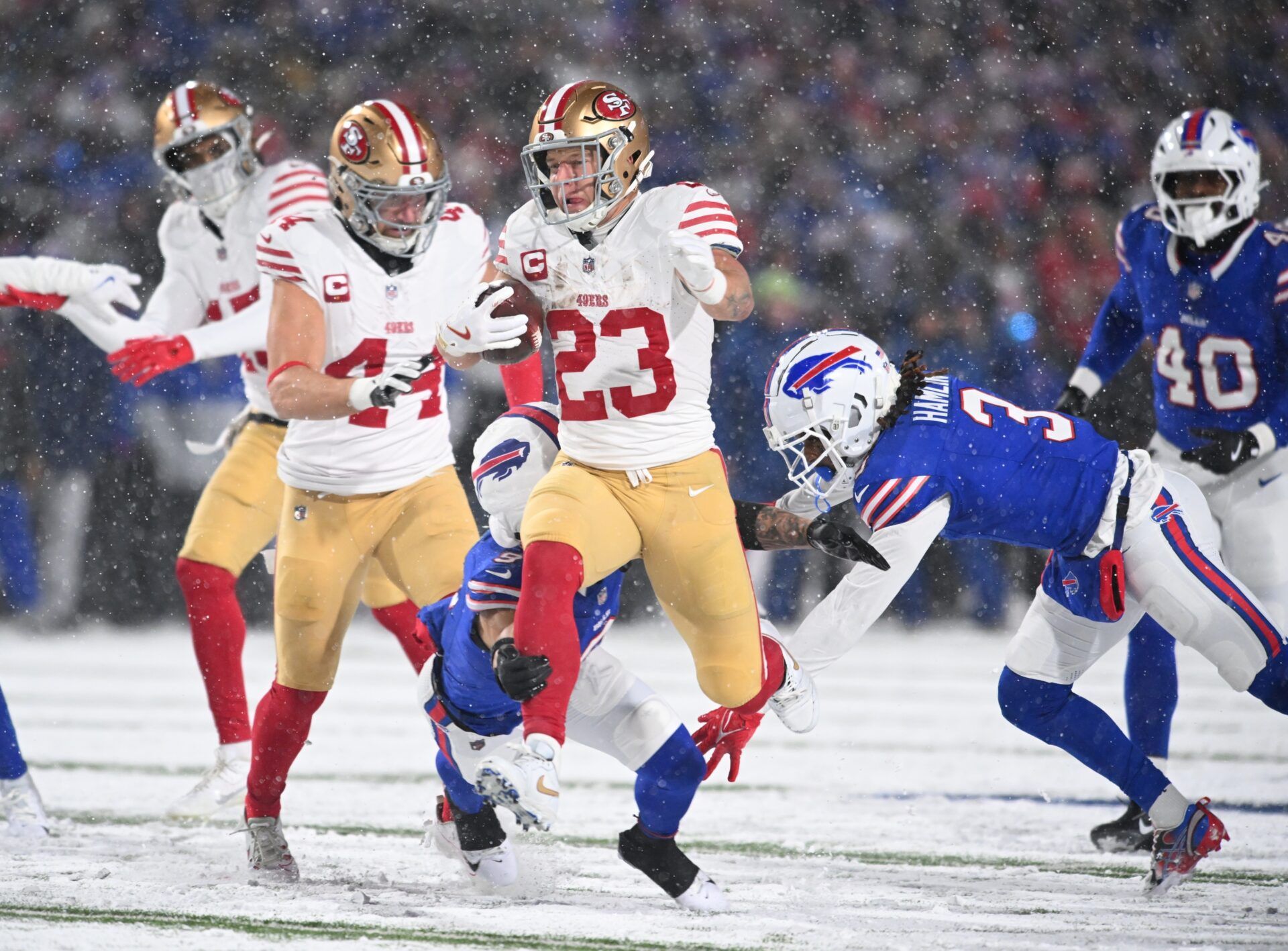 Dec 1, 2024; Orchard Park, New York, USA; San Francisco 49ers running back Christian McCaffrey (23) is tackled by Buffalo Bills safety Taylor Rapp (9) and safety Damar Hamlin (3) in the second quarter at Highmark Stadium. Mandatory Credit: Mark Konezny-Imagn Images