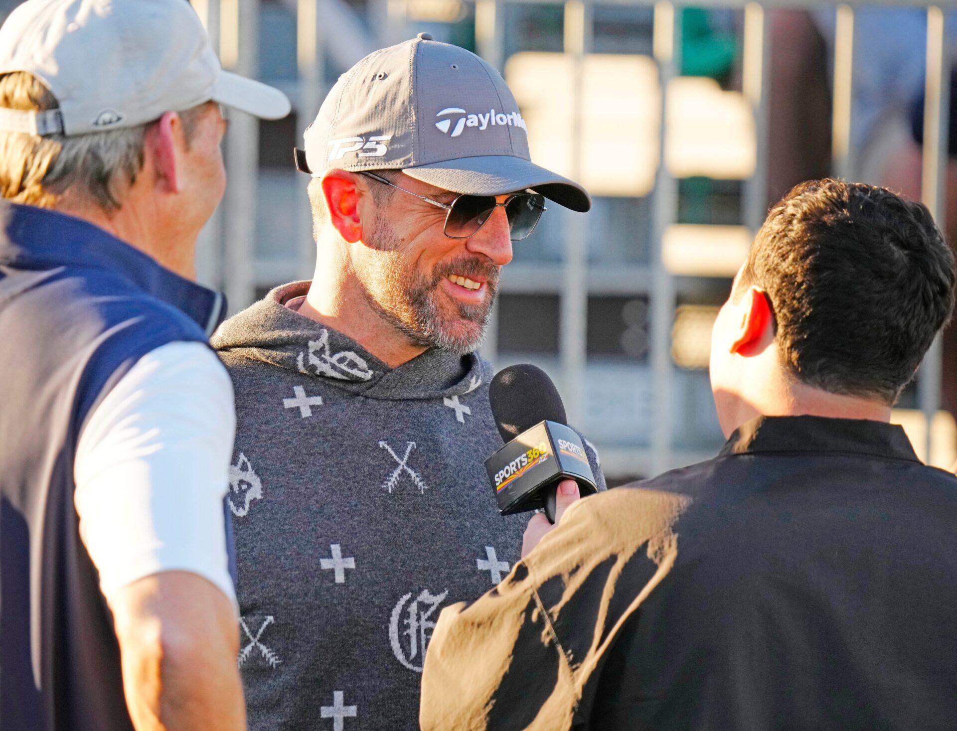 FeJets quarterback Aaron Rodgers talks with the press on the first tee box during the Phoenix Open Annexus Pro-Am at TPC Scottsdale.