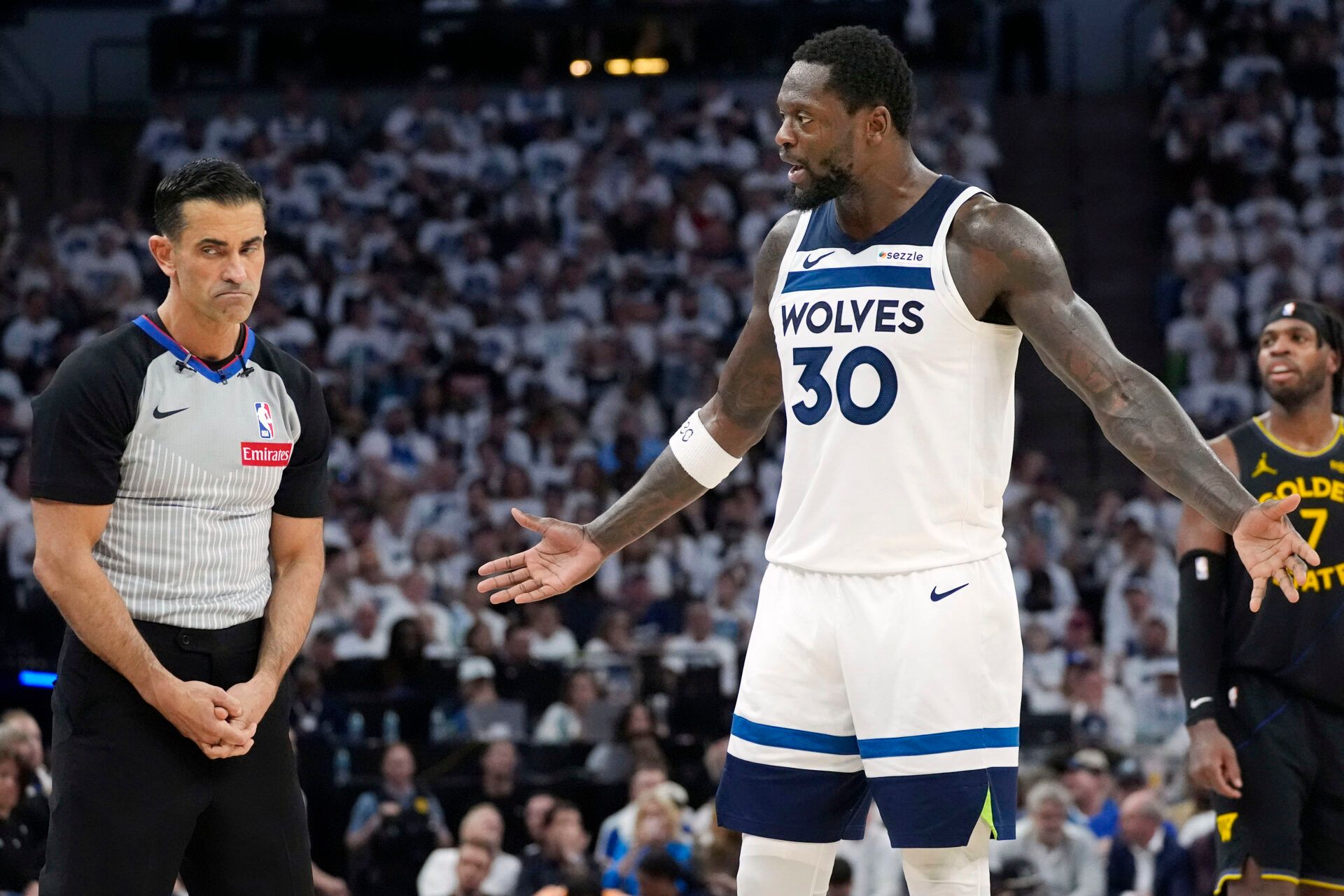 May 6, 2025; Minneapolis, Minnesota, USA; Minnesota Timberwolves forward Julius Randle (30) questions the call of referee Zach Zarba in the third quarter during game one of the second round for the 2025 NBA Playoffs with the Golden State Warriors at Target Center. Mandatory Credit: Bruce Kluckhohn-Imagn Images