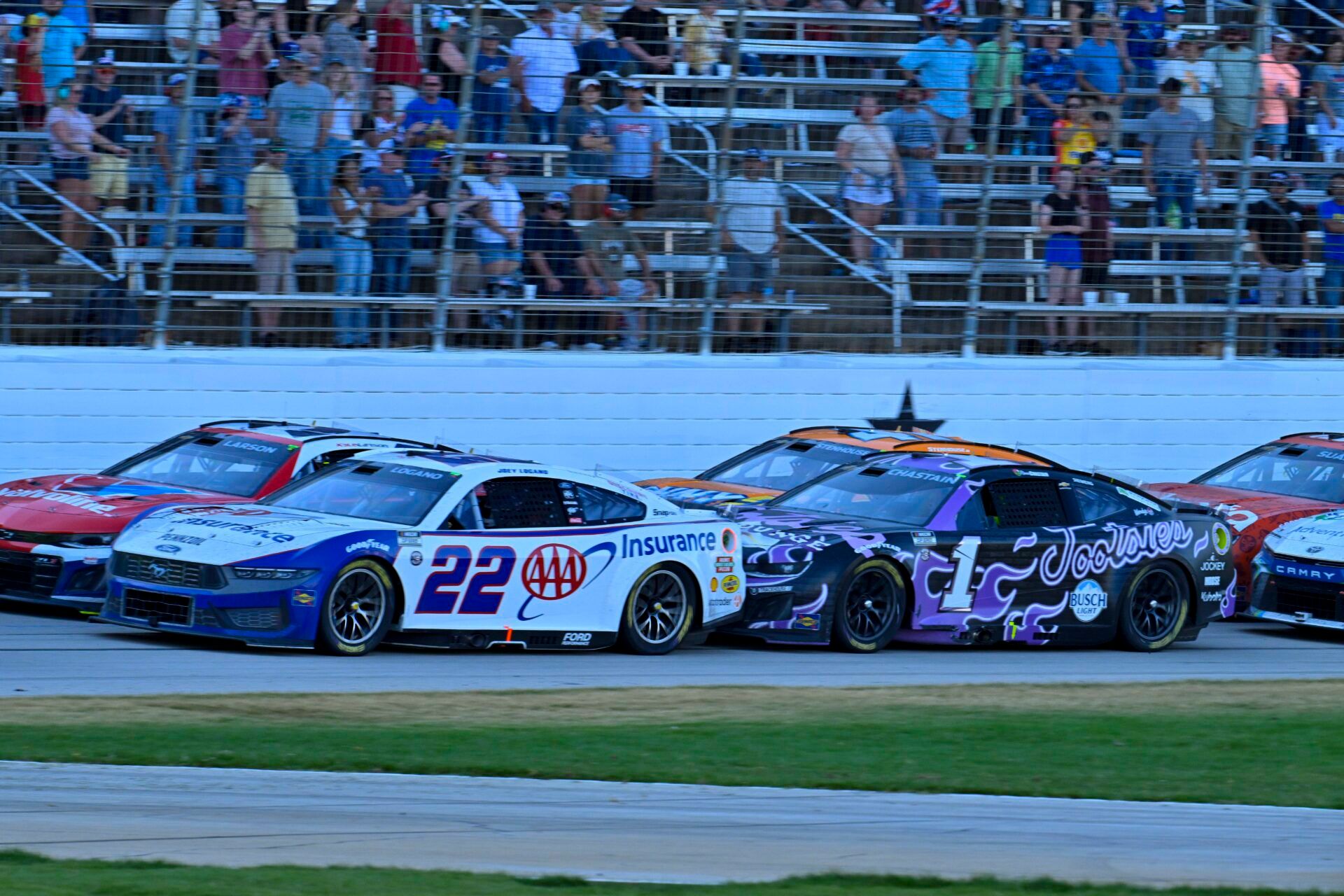 May 4, 2025; Fort Worth, Texas, USA; NASCAR Cup Series driver Kyle Larson (5) and driver Joey Logano (22) and driver Ross Chastain (1) and driver Ricky Stenhouse Jr. (47) drives during a restart of the Wurth 400 race at Texas Motor Speedway. Mandatory Credit: Jerome Miron-Imagn Images