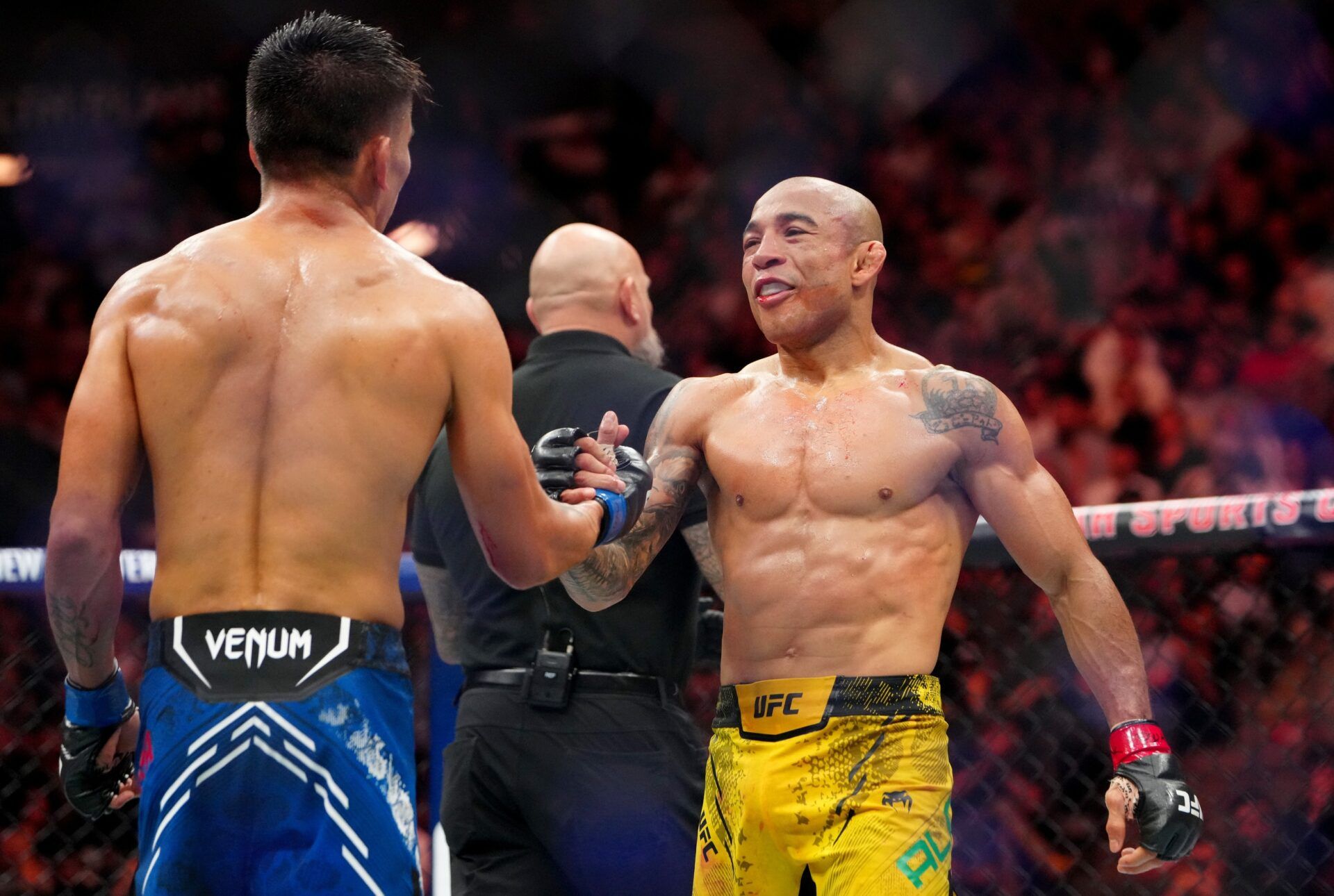 Oct 5, 2024; Salt Lake City, Utah, USA; Jose Aldo (red gloves) shakes hands with Mario Bautista (blue gloves) after their fight during UFC 307 at Delta Center. Mandatory Credit: Stephen R. Sylvanie-Imagn Images