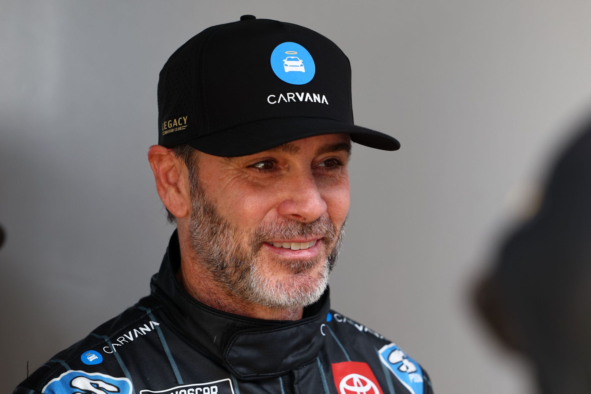Feb 16, 2025; Daytona Beach, Florida, USA; NASCAR Cup Series driver Jimmie Johnson (84) walks to the drivers meeting before the Daytona 500 at Daytona International Speedway. Mandatory Credit: Peter Casey-Imagn Images