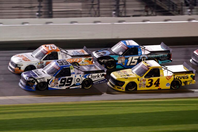 Feb 14, 2025; Daytona Beach, Florida, USA; NASCAR Truck Series driver Ben Rhodes (99) and driver Parker Kligerman (75) race side by side during the Fresh From Florida 250 at Daytona International Speedway. Mandatory Credit: Peter Casey-Imagn Images