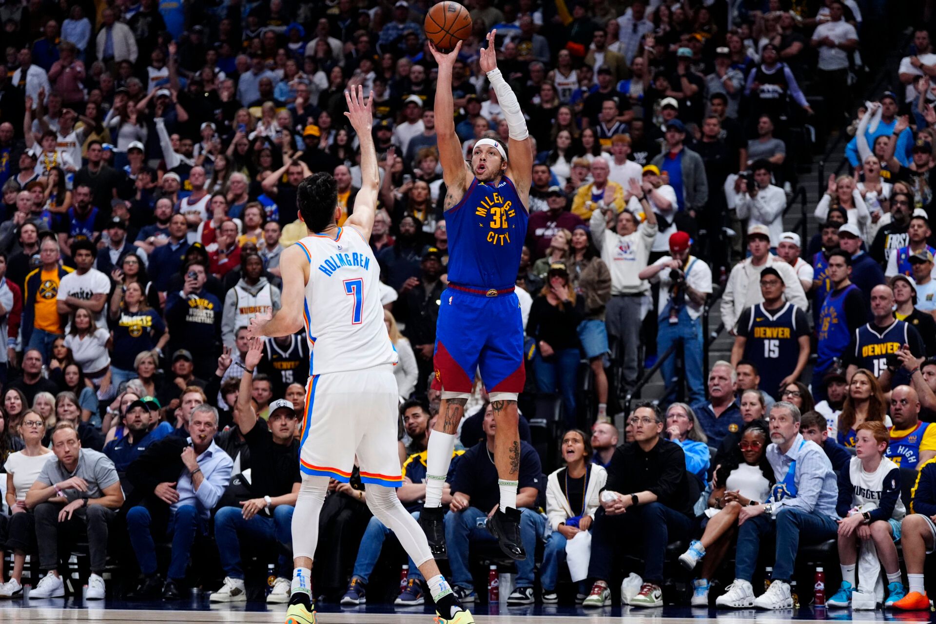 Denver Nuggets forward Aaron Gordon (32) shoots a three point basket over Oklahoma City Thunder forward Chet Holmgren (7) in the fourth quarter during game three of the second round for the 2025 NBA Playoffs at Ball Arena.