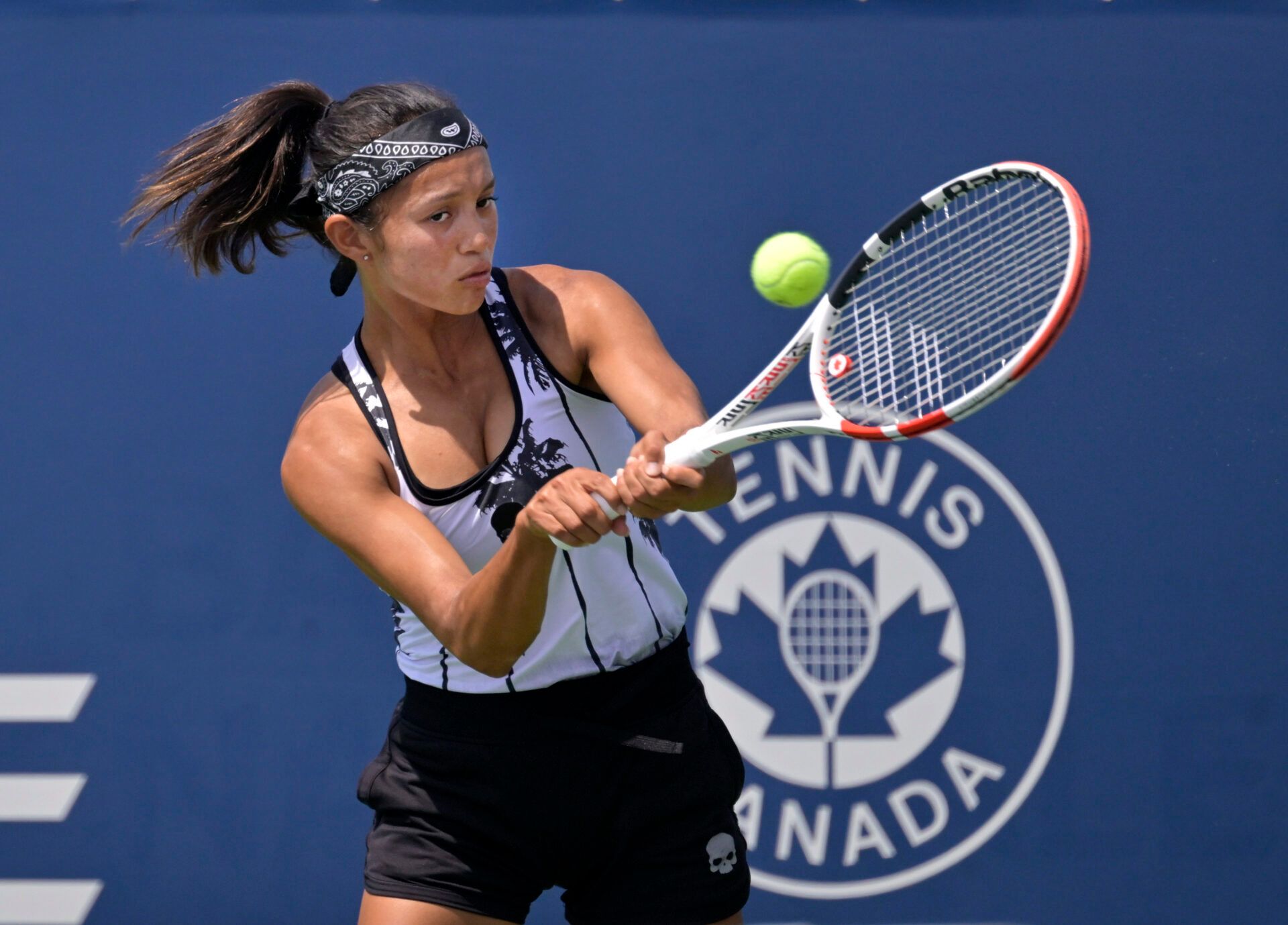Bianca Fernandez (BF) hits a backhand against Lesia Tsurenko (UKR) (not pictured) in first round qualifying play at IGA Stadium.
