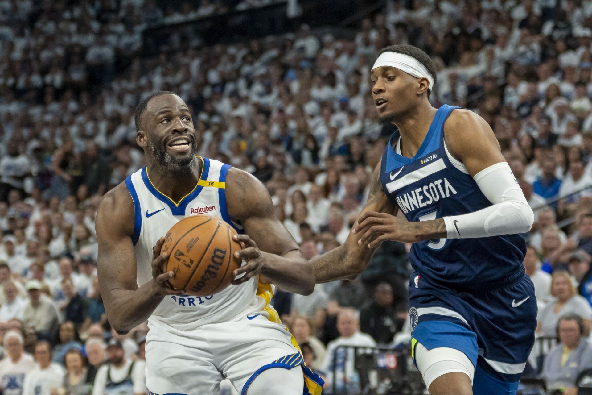 Golden State Warriors forward Draymond Green (23) drives to the basket past Minnesota Timberwolves forward Jaden McDaniels (3) in the second half during game two of the second round for the 2025 NBA Playoffs at Target Center.