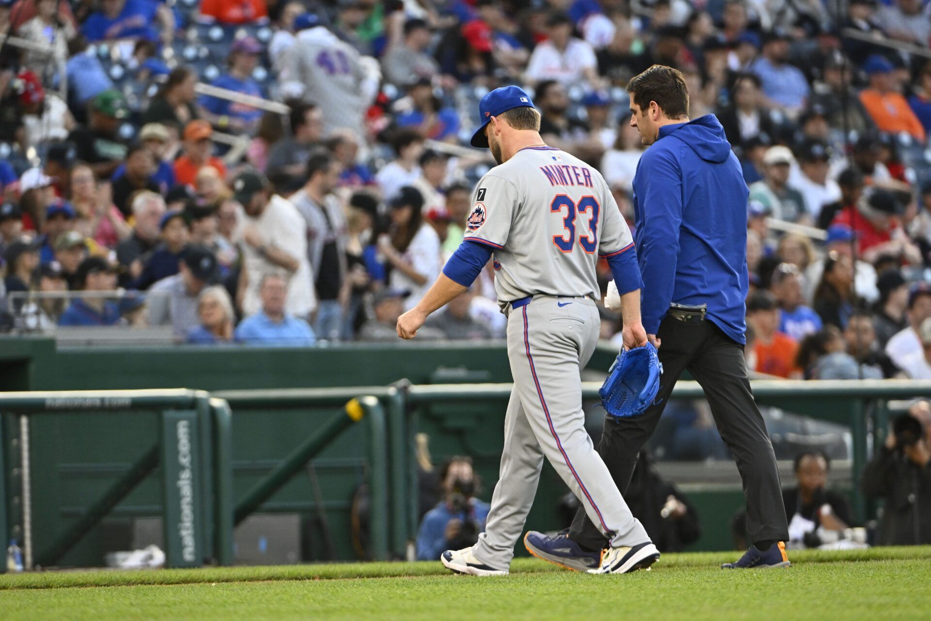 New York Mets pitcher A.J. Minter (33) leaves the game with an apparent injury against the Washington Nationals during the eighth inning at Nationals Park.