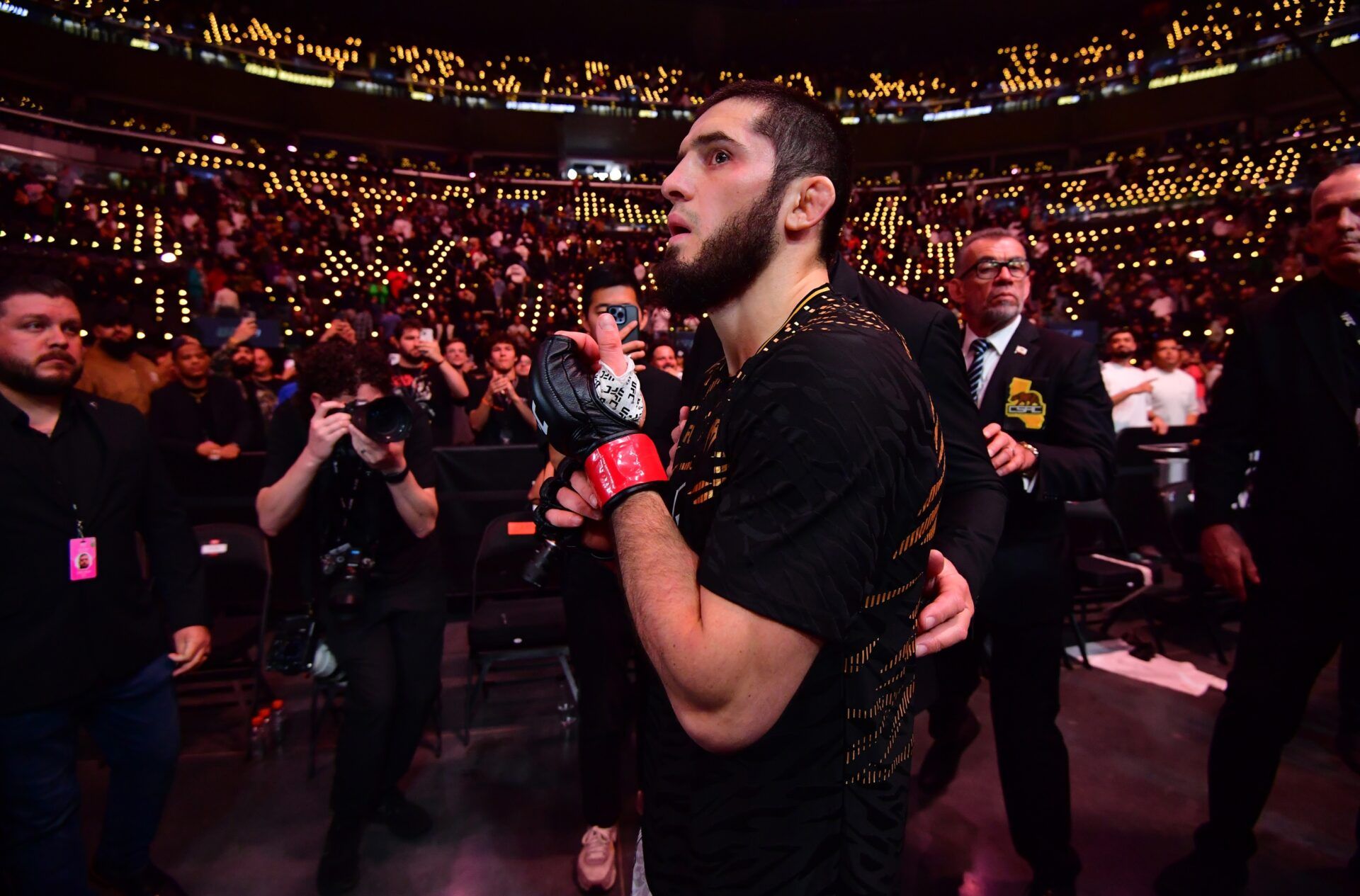 Islam Makhachev (red gloves) leaves the octagon after defeating Renato Moicano (not pictured) in a lightweight title fight during UFC 311 at Intuit Dome.
