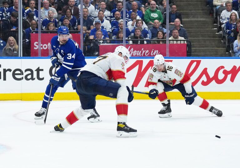 Toronto Maple Leafs center Auston Matthews (34) battles for the puck with Florida Panthers center Aleksander Barkov (16) during the third period in game two of the second round of the 2025 Stanley Cup Playoffs at Scotiabank Arena.