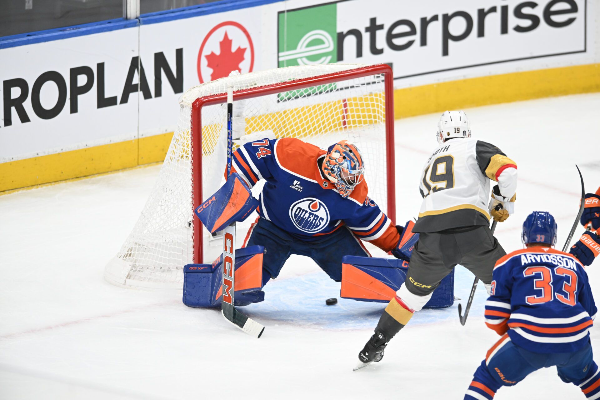 May 10, 2025; Edmonton, Alberta, CAN : Edmonton Oilers goalie Stuart Skinner (74) looks for the puck as Las Vegas Golden Knights  right winger Reilly Smith (19) shoots during the first period in game three of the second round of the 2025 Stanley Cup Playoffs at Rogers Place.