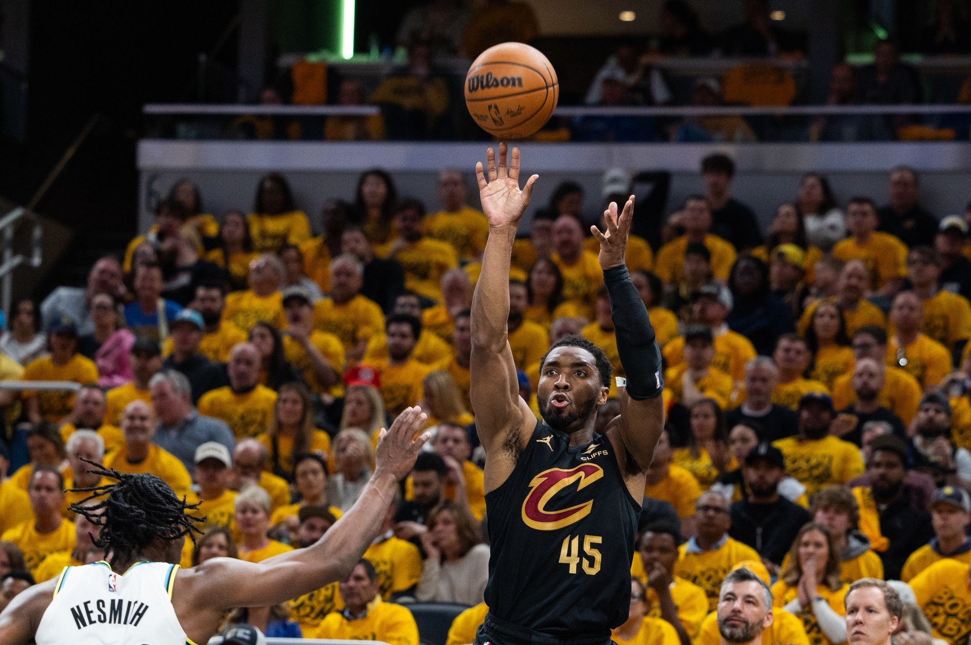 Cleveland Cavaliers guard Donovan Mitchell (45) shoots the ball while  Indiana Pacers forward Aaron Nesmith (23) defends during game three of the second round for the 2025 NBA Playoffs at Gainbridge Fieldhouse.