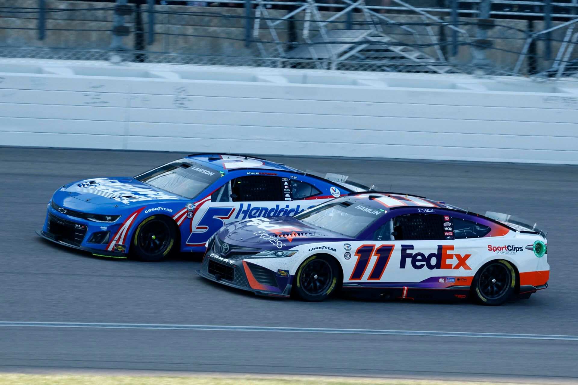 NASCAR Cup Series driver Denny Hamlin (11) attempts to take the lead from driver Kyle Larson (5) during the AdventHealth 400 at Kansas Speedway.